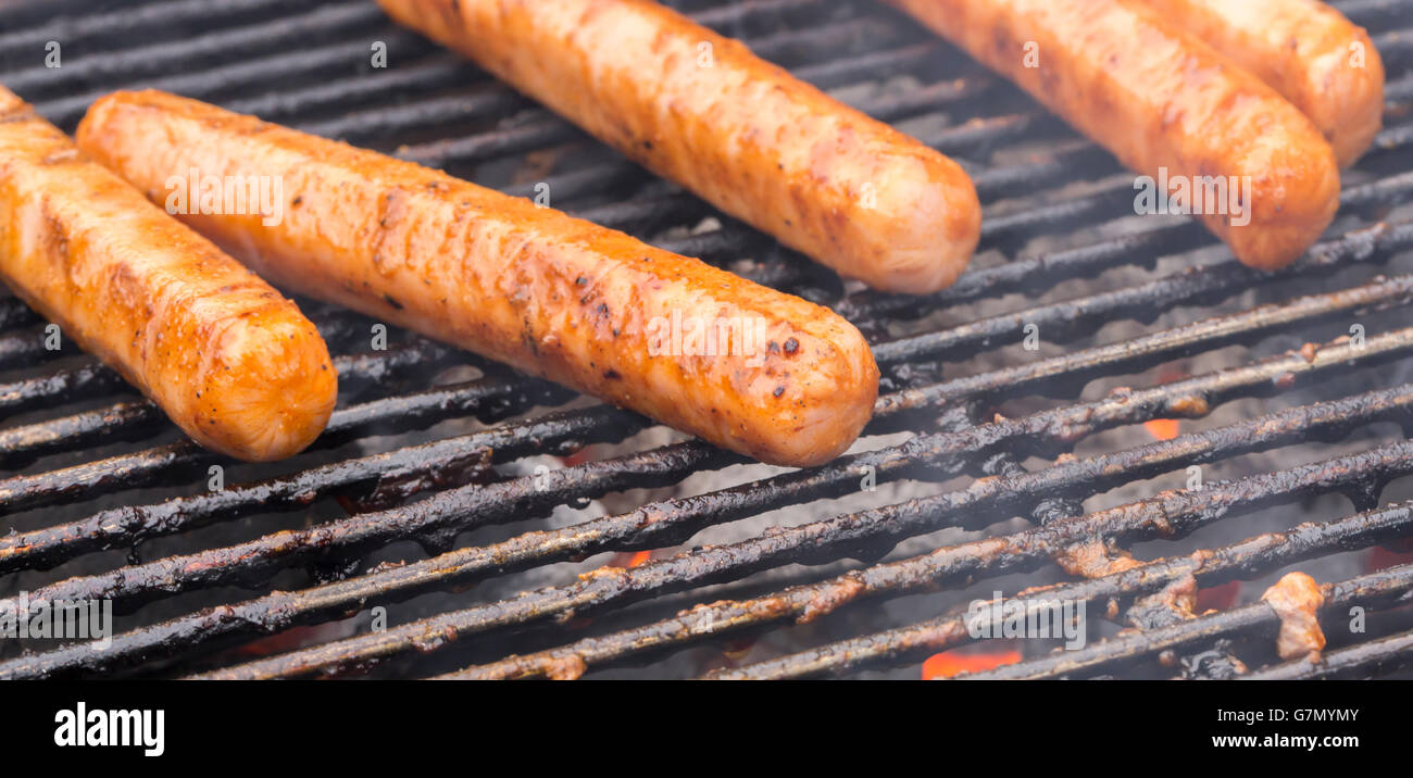 Hot Dogs on Grill Grate close up. Stock Photo
