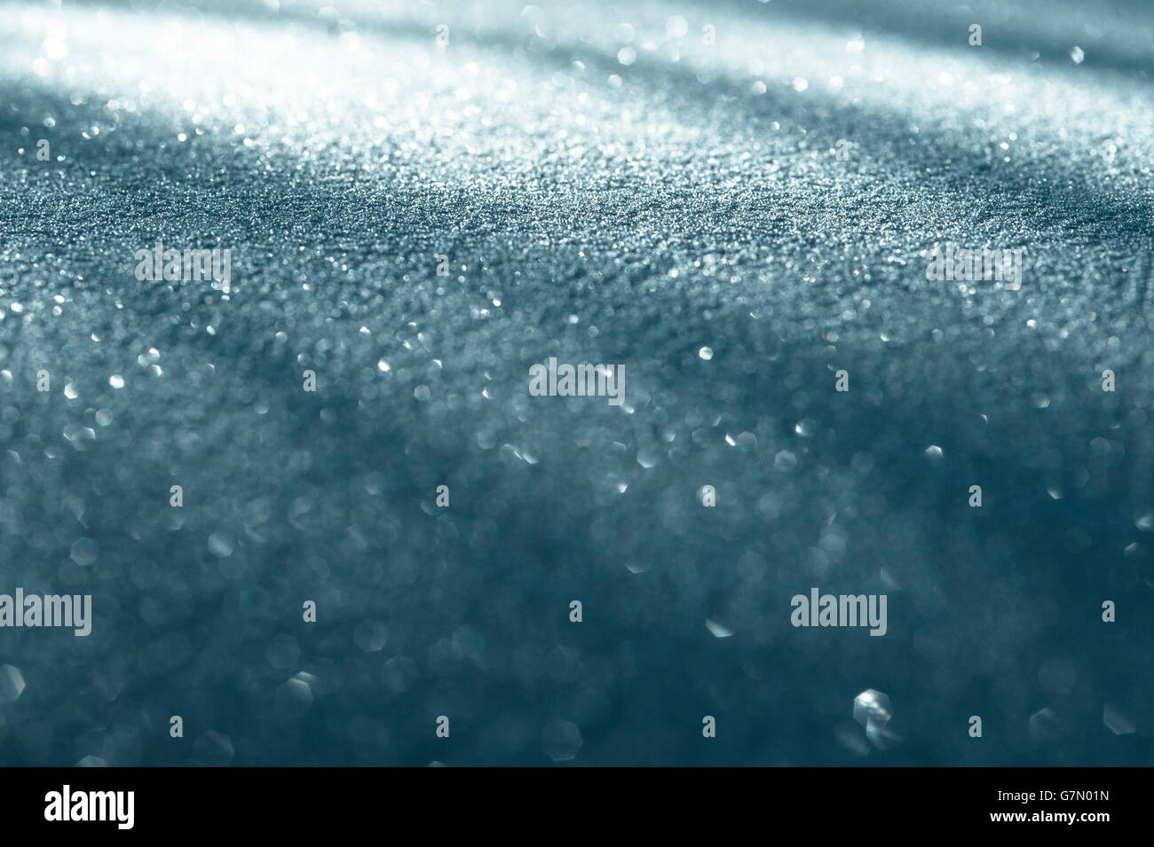 Sunrise with car hood covered in snow with light patterns, Stock Photo