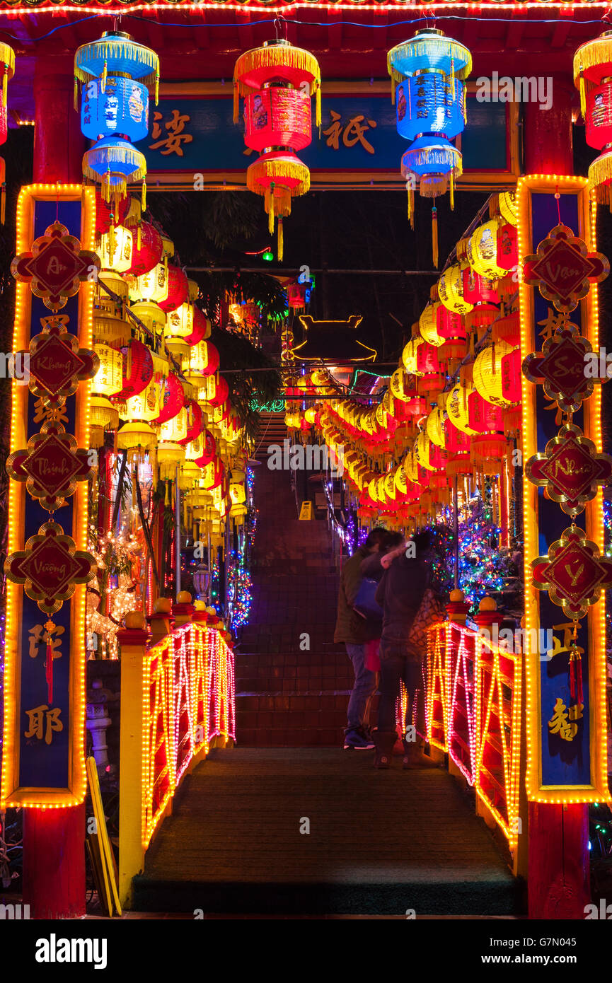 Multicolored lights lining stairs leading to Buddhist Temples Stock Photo