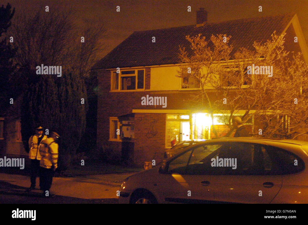 Police officers stand outside house in mere close hires stock