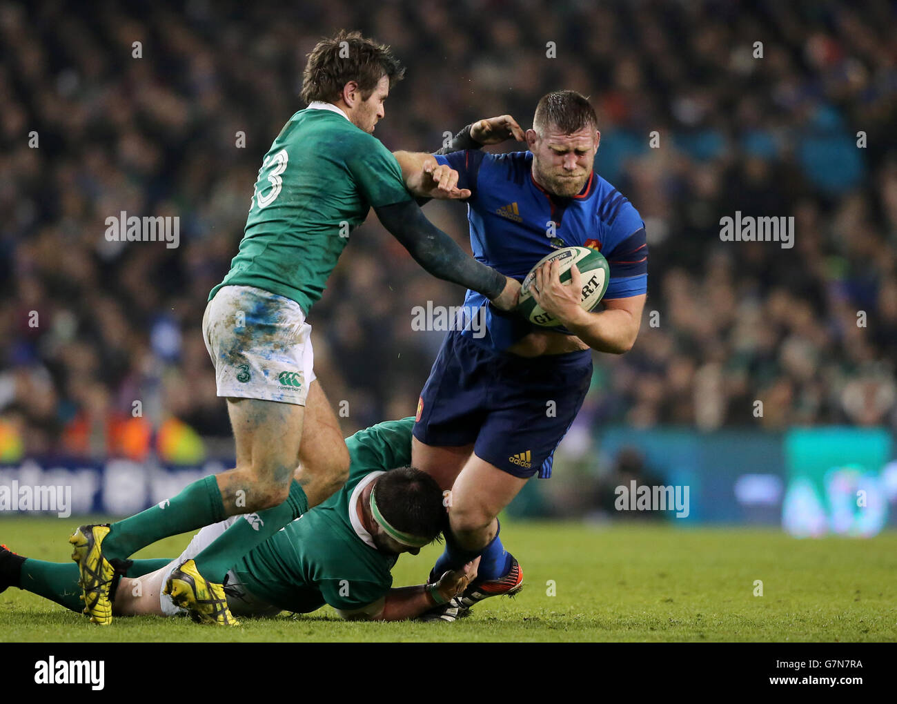 France's Vincent Debaty (centre) is tackled by Ireland's Jared Payne and Martin Moore (floor) during the 6 Nations match at Aviva Stadium, Dublin. Stock Photo