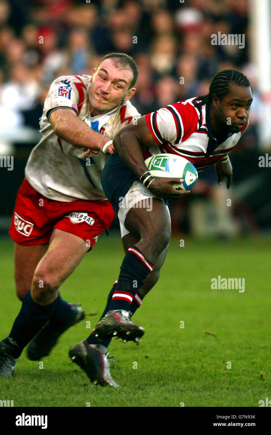 Gloucester's Marcel Garvey (R) tries to escape the cluches of Stade Francais' Olivier Brouzet. Stock Photo
