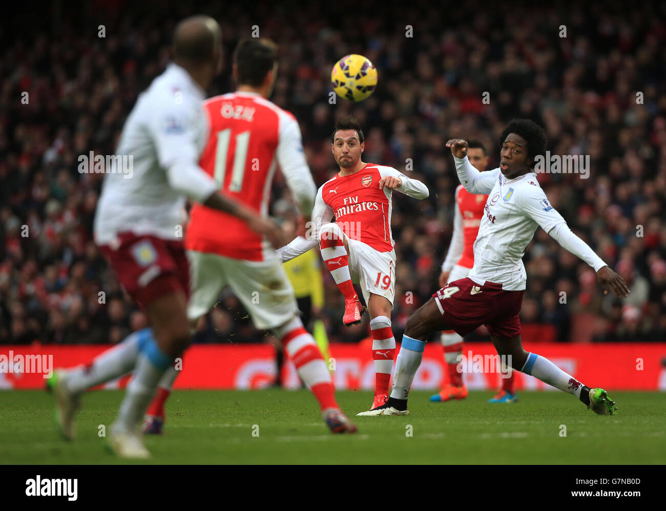 Arsenal's Santi Cazorla chips ball during the Barclays Premier League match at the Emirates Stadium, London. Stock Photo