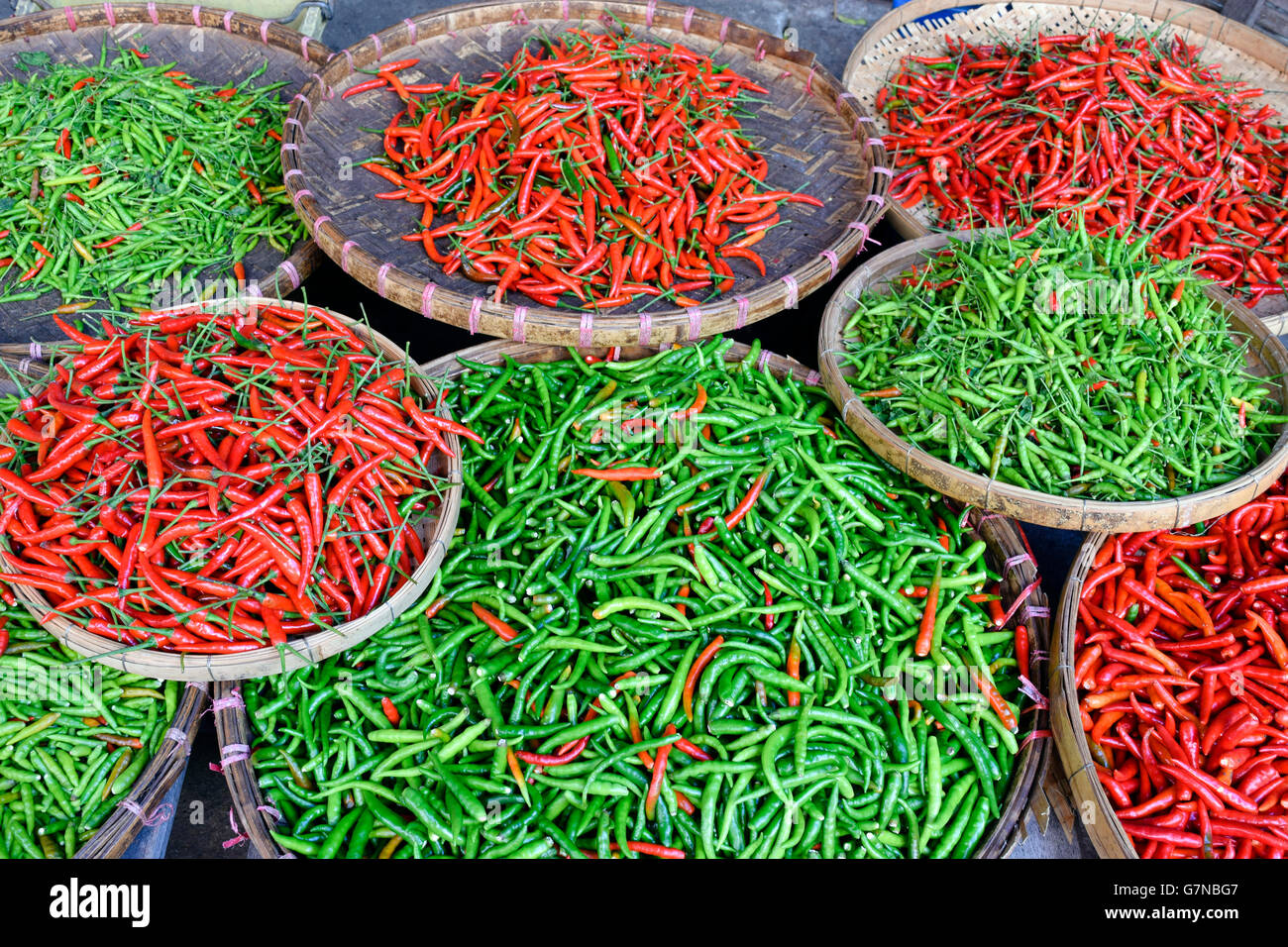 An arrangement of red and green Thai chili peppers in an Asian market in Thailand. Stock Photo
