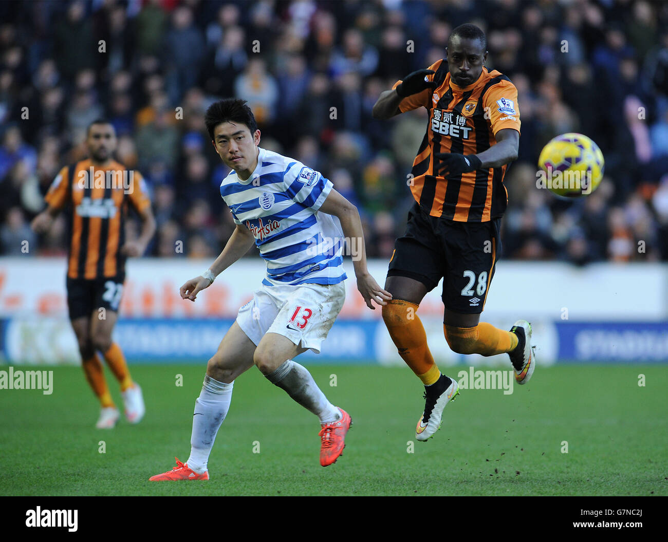 QPR's Yun Suk-Young and Hull City's Dame N'Doye in action during the Barclays Premier League match at the KC Stadium, Hull. Stock Photo