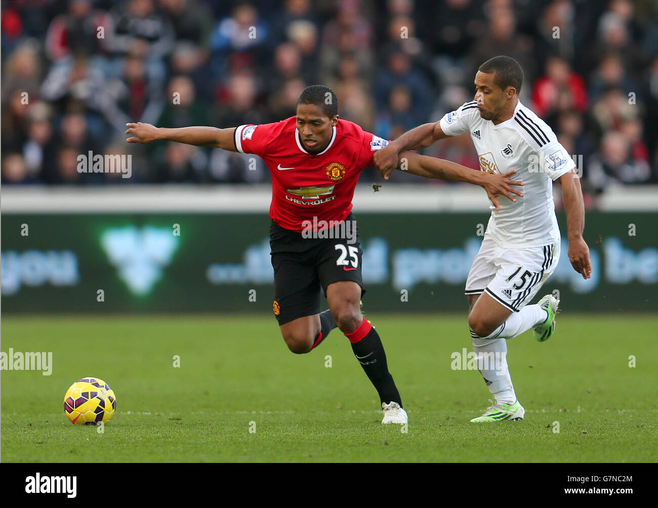 Manchester United's Antonio Valencia and Swansea City's Wayne Routledge battle for the ball during the Barclays Premier League match at the Liberty Stadium, Swansea. PRESS ASSOCIATION Photo. Picture date: Saturday February 21, 2015. See PA story SOCCER Swansea. Photo credit should read: David Davies/PA Wire. Stock Photo