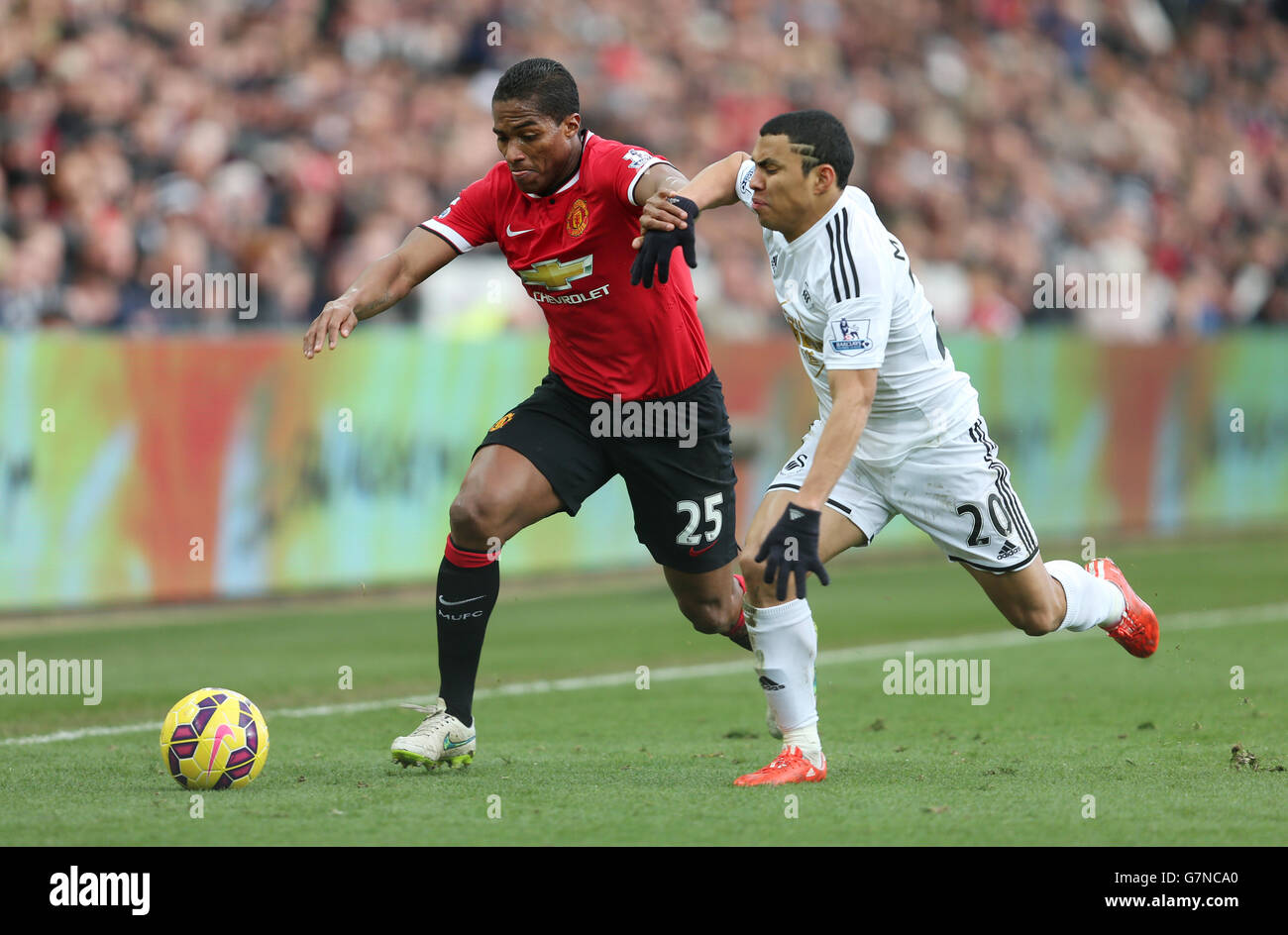 Manchester United's Antonio Valencia and Swansea City's Jefferson Montero during the Barclays Premier League match at the Liberty Stadium, Swansea. PRESS ASSOCIATION Photo. Picture date: Saturday February 21, 2015. See PA story SOCCER Swansea. Photo credit should read: David Davies/PA Wire. Stock Photo