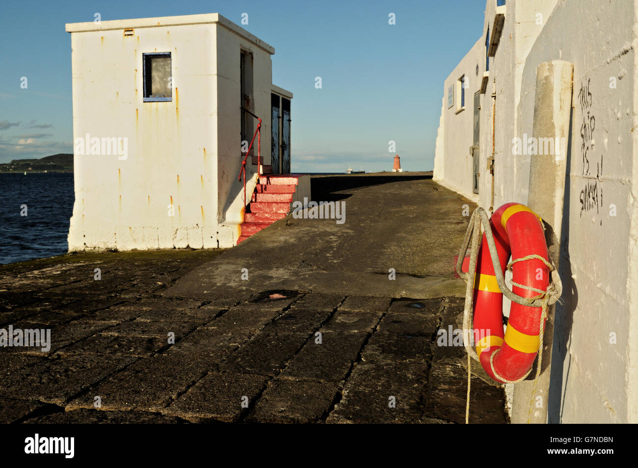 Lifebuoy and buildings along the Great South Wall in Dublin Bay, Ireland Stock Photo