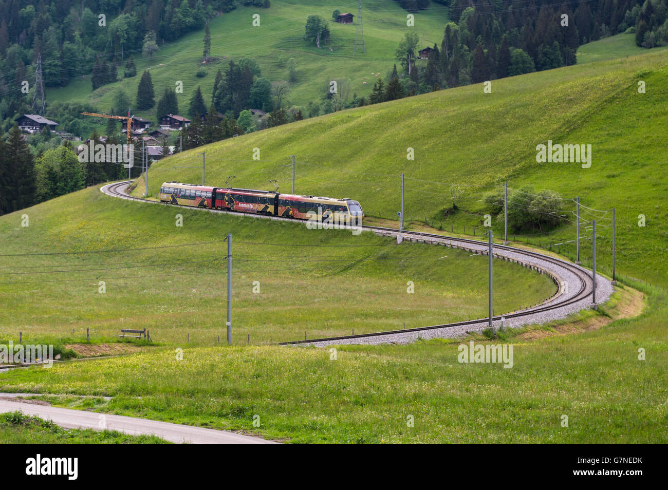 Electric multiple unit train of the MOB Montreux-Oberland Bernois railway on the GoldenPass Line close to Gstaad, Switzerland. Stock Photo