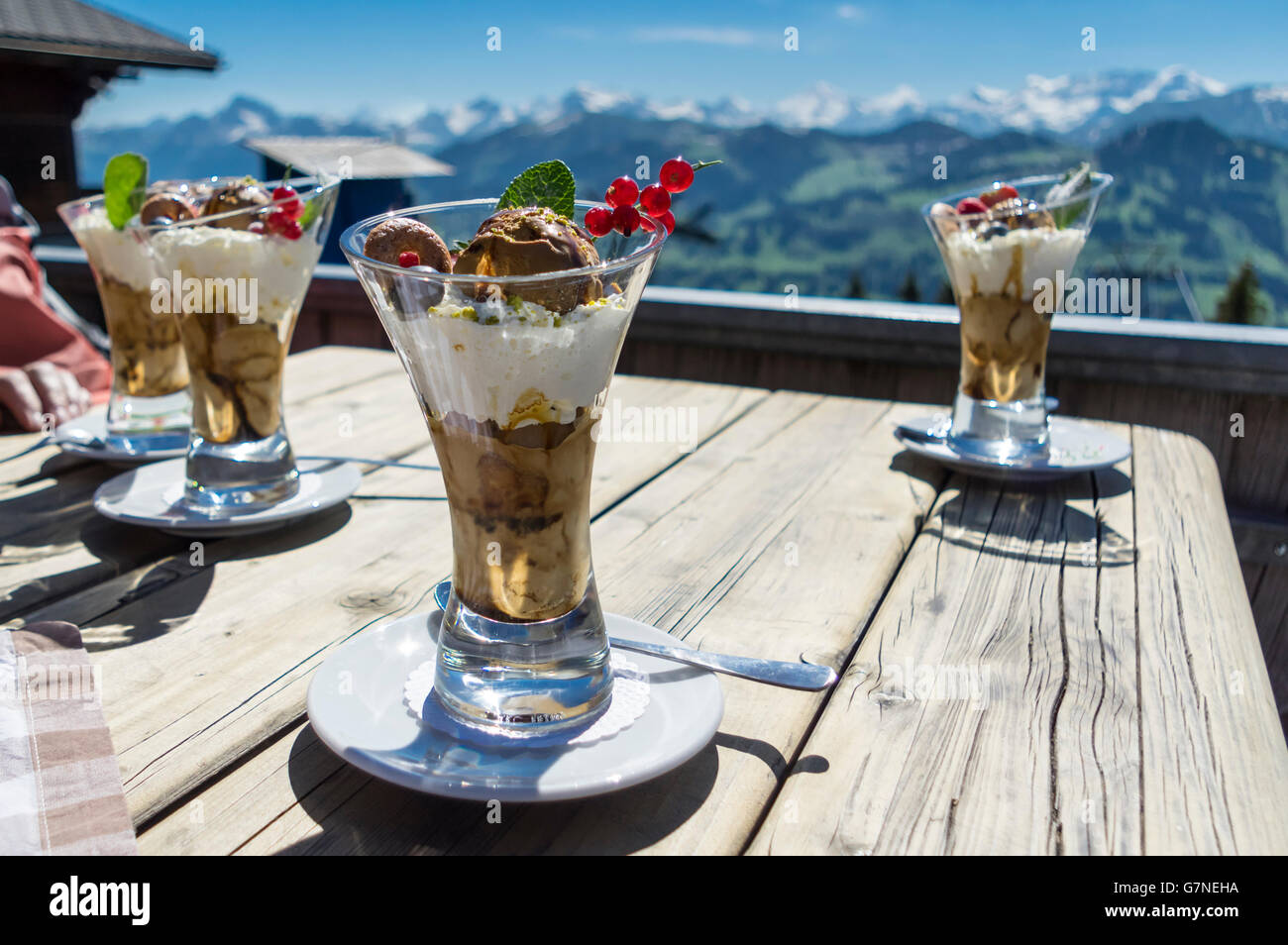 Iced coffee sundae served outdoors in the Swiss Alps. Mocha ice cream with coffee, coffee syrup and whipped cream. Stock Photo