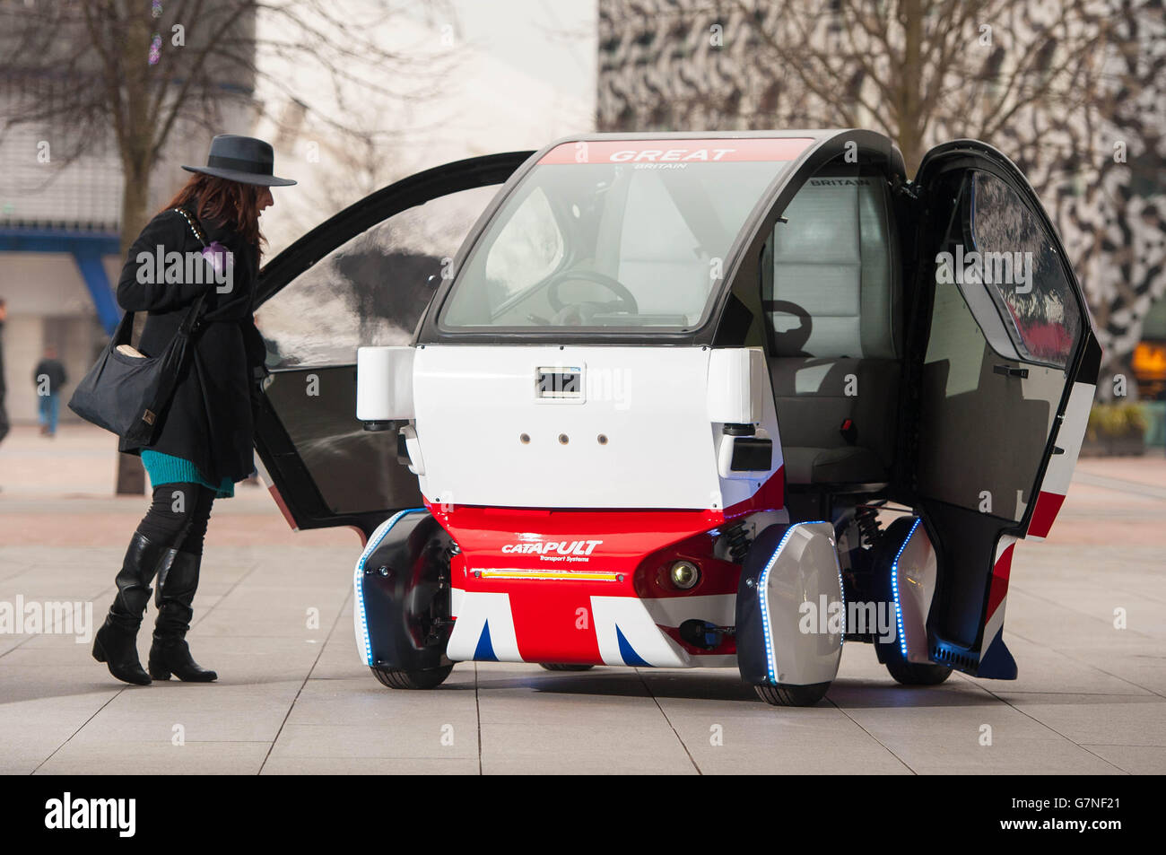 A woman looks at a prototype of the Pathfinder driverless pod, that will be the first autonomous vehicle in the UK to work on public footpaths, which has been unveiled today by the Transport Systems Catapult at a Government launch event in Greenwich, London. Stock Photo