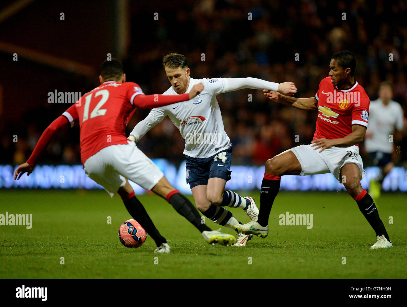 Preston North End's Joe Garner (centre) in action with Manchester United's Luis Antonio Valencia (right) and Chris Smalling during the FA Cup Fifth Round match at Deepdale Stadium, Preston. PRESS ASSOCIATION Photo. Picture date: Monday February 16, 2015. See PA story SOCCER Preston. Photo credit should read: Martin Rickett/PA Wire. Stock Photo