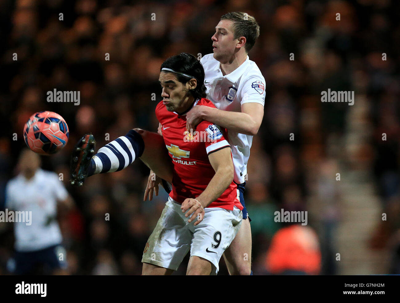 Manchester United's Radamel Falcao (left) and Preston North End's Paul Huntington (right) battle for the ball. Stock Photo