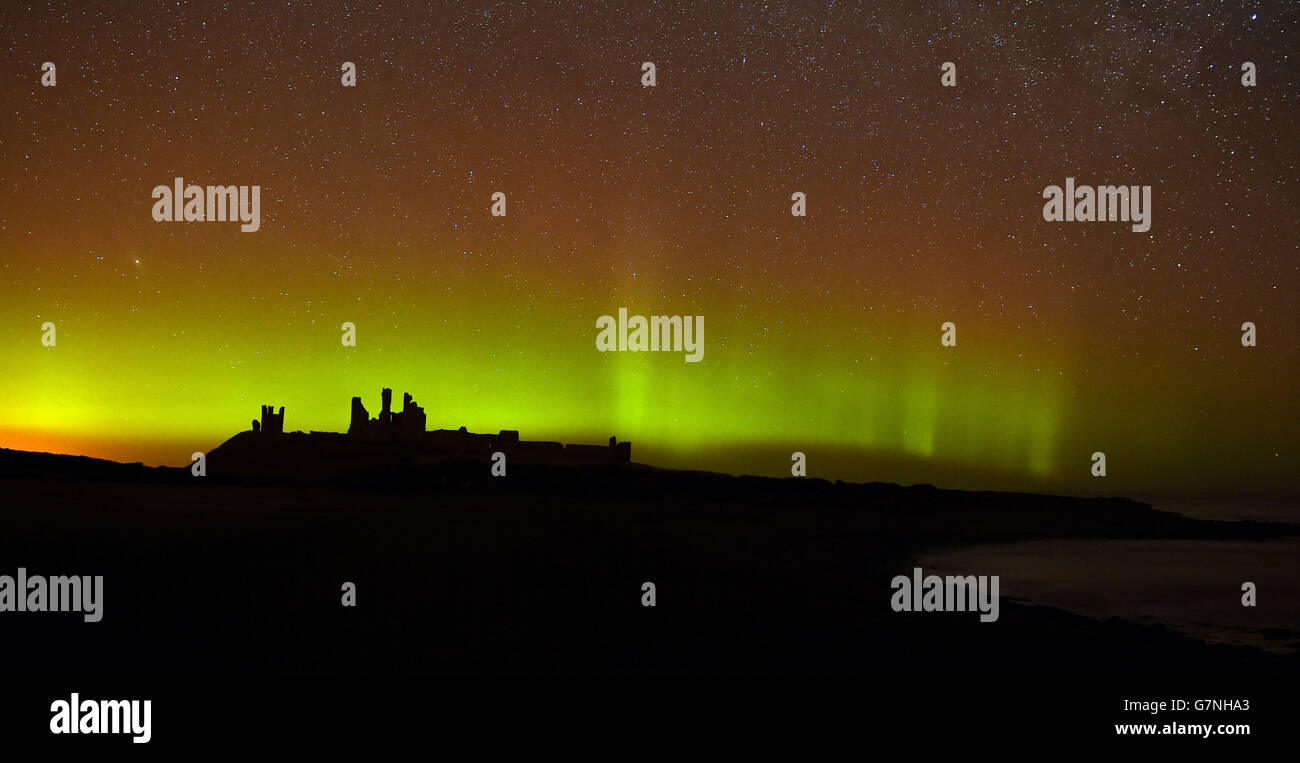 The aurora borealis, or the northern lights as they are commonly known at Dunstanburgh Castle in Northumberland. Stock Photo