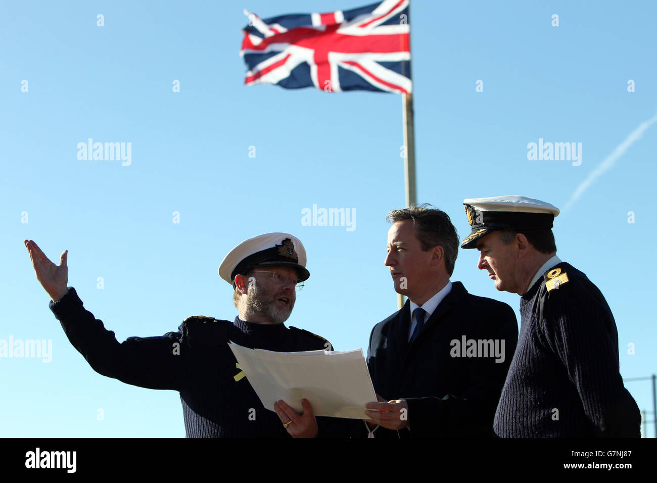 Prime Minister David Cameron looks at plans with Captain Iain Greenlees ...