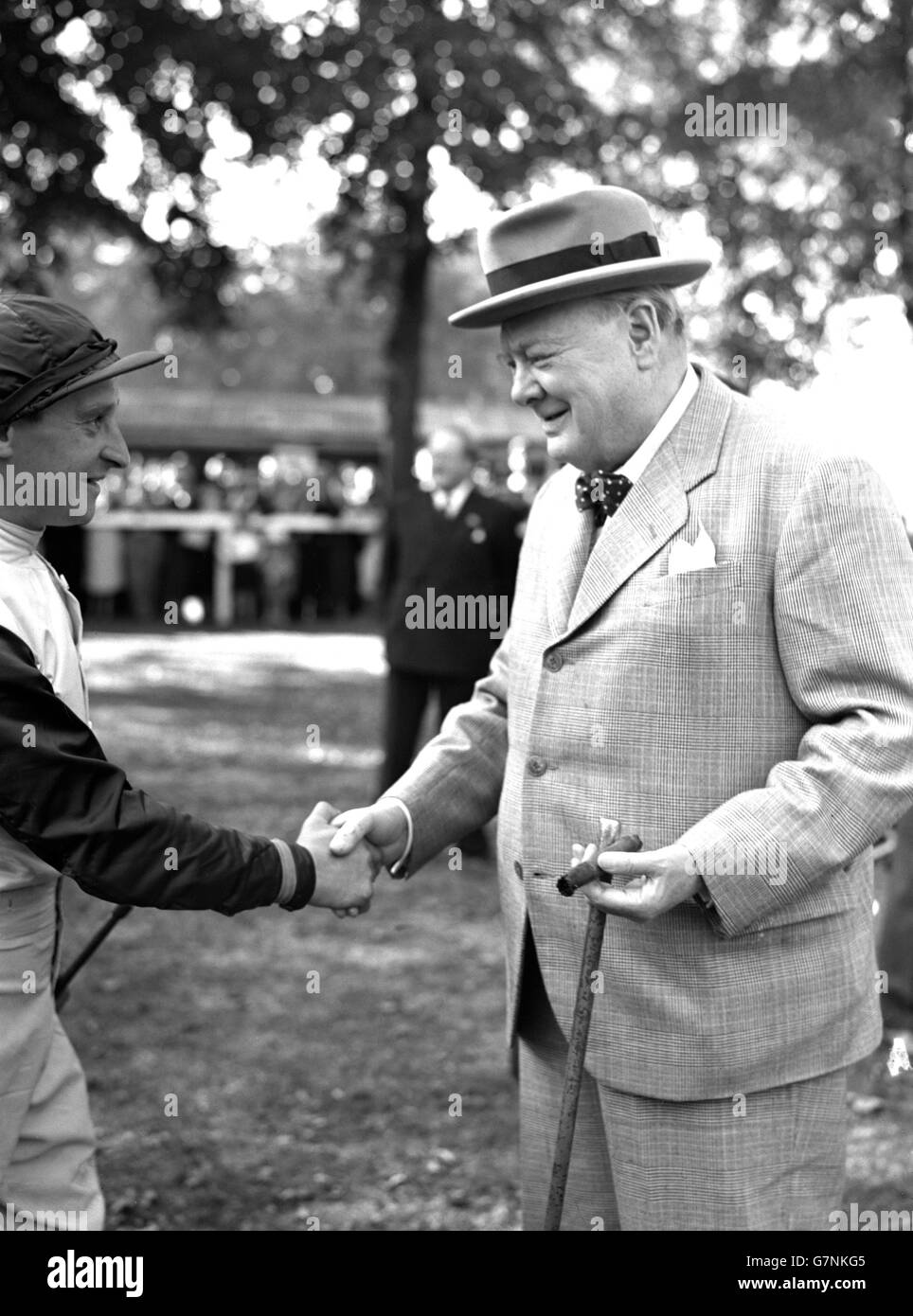 Horse Racing - Winston Churchill - Windsor, Berkshire. Winston Churchill shakes hands with jockey Tommy Hawcroft, who rode his horse Colonist II to victory at Windsor. Stock Photo