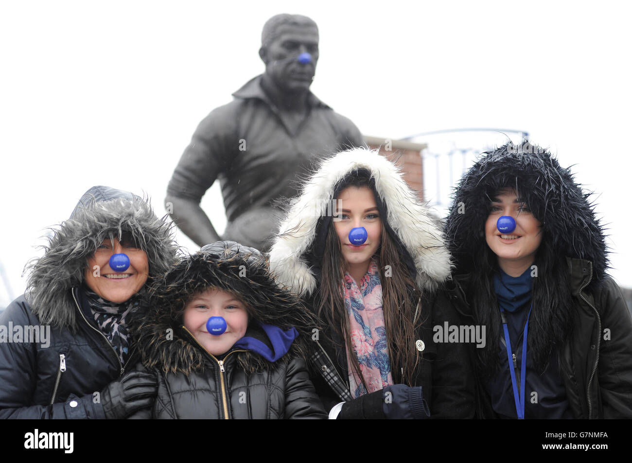 Everton's Dixie Dean statue wears a blue nose for Blue Nose Day as fans also wear them in front of it Stock Photo
