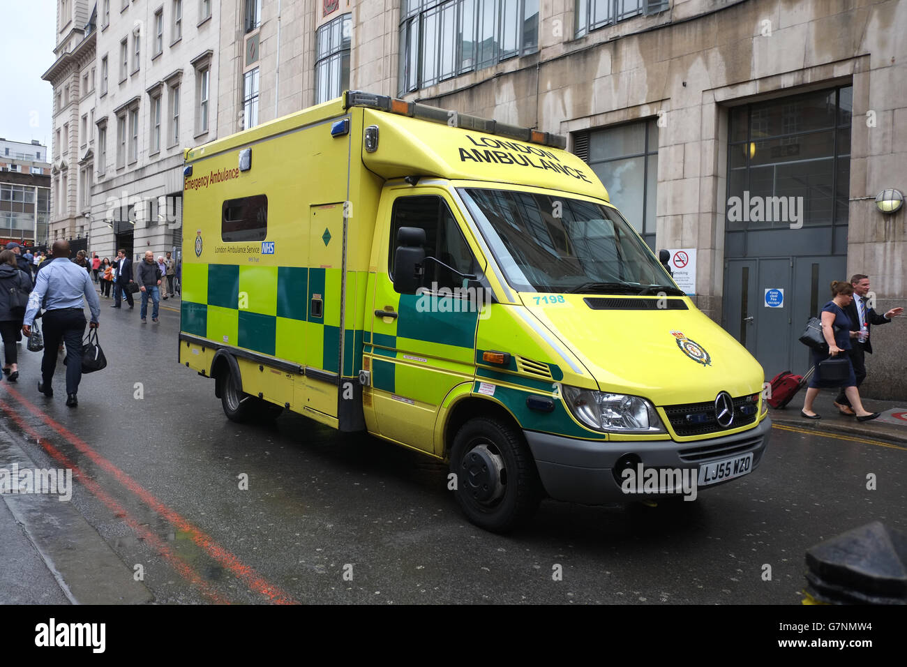 Yellow British ambulance at Paddington station in London.  June 21st 2016 Stock Photo
