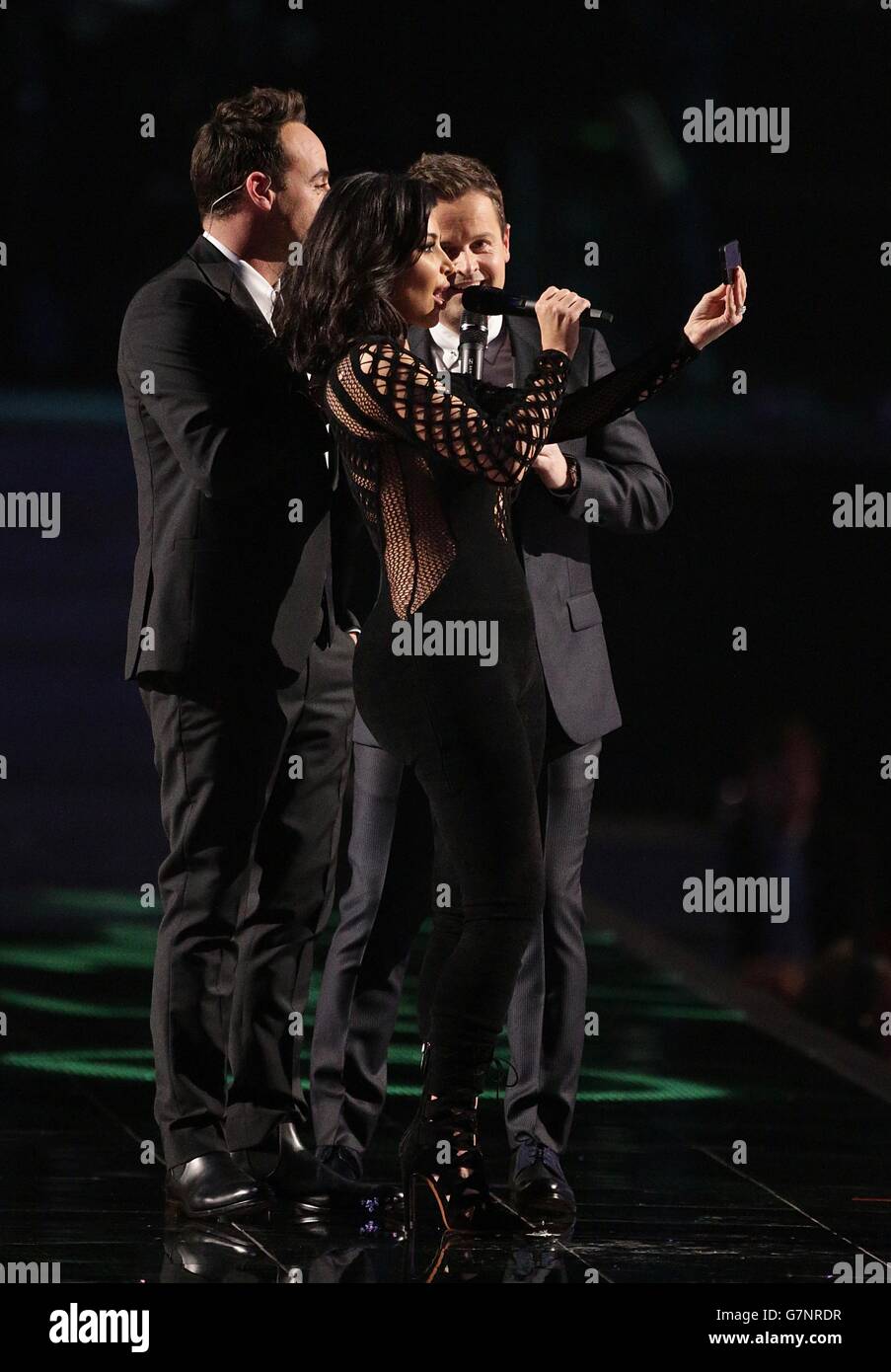 Kim Kardashian takes a selfie on stage with presenters Ant (left) and