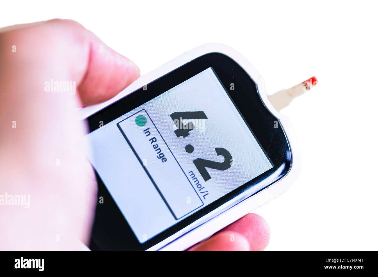 Blood glucose monitor showing a glucose level of 4.2mmol/L, within the normal range of 4.0 to 5.9 mmol/L under normal conditions Stock Photo