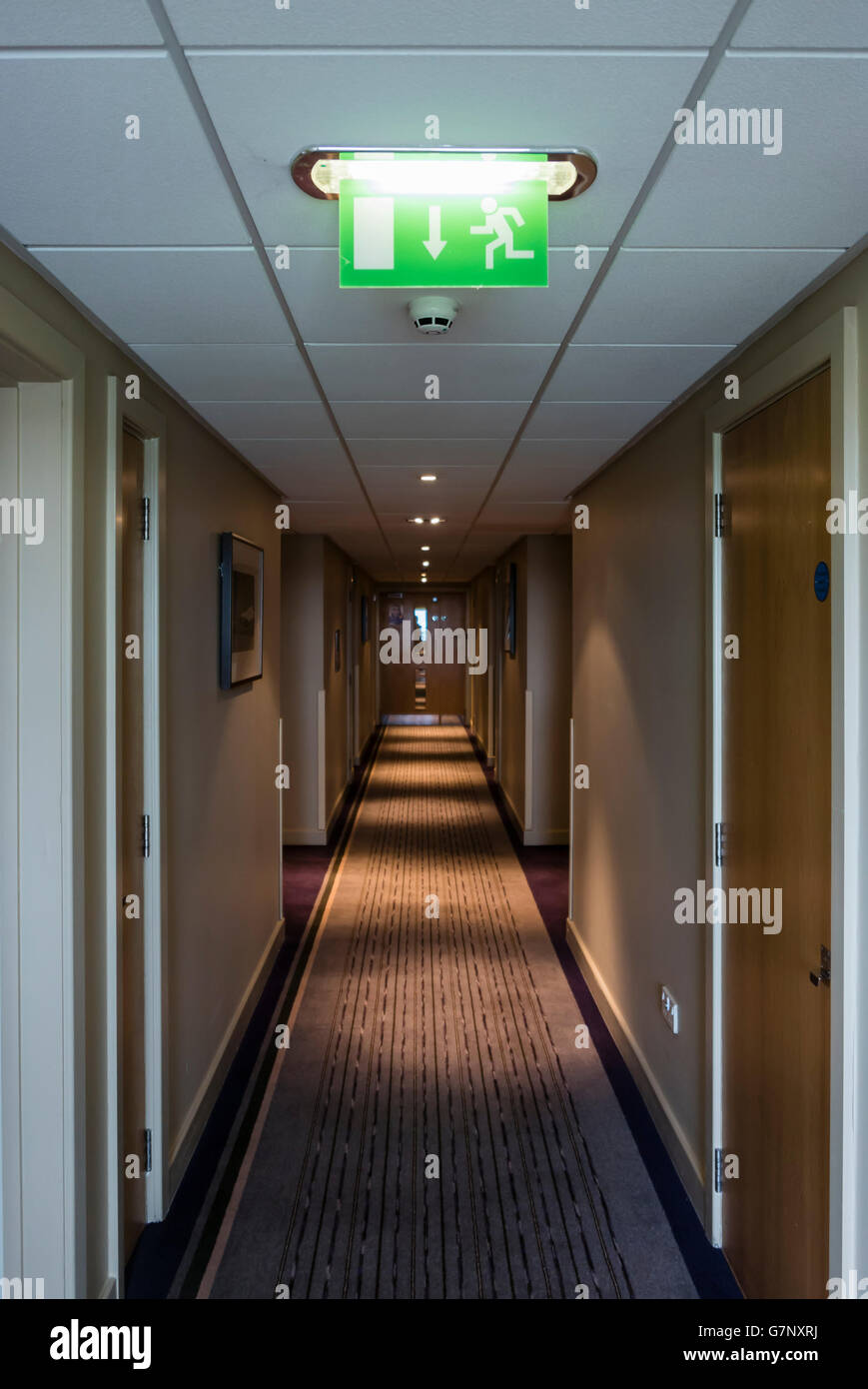 Fire escape sign in a hotel corridor. Stock Photo