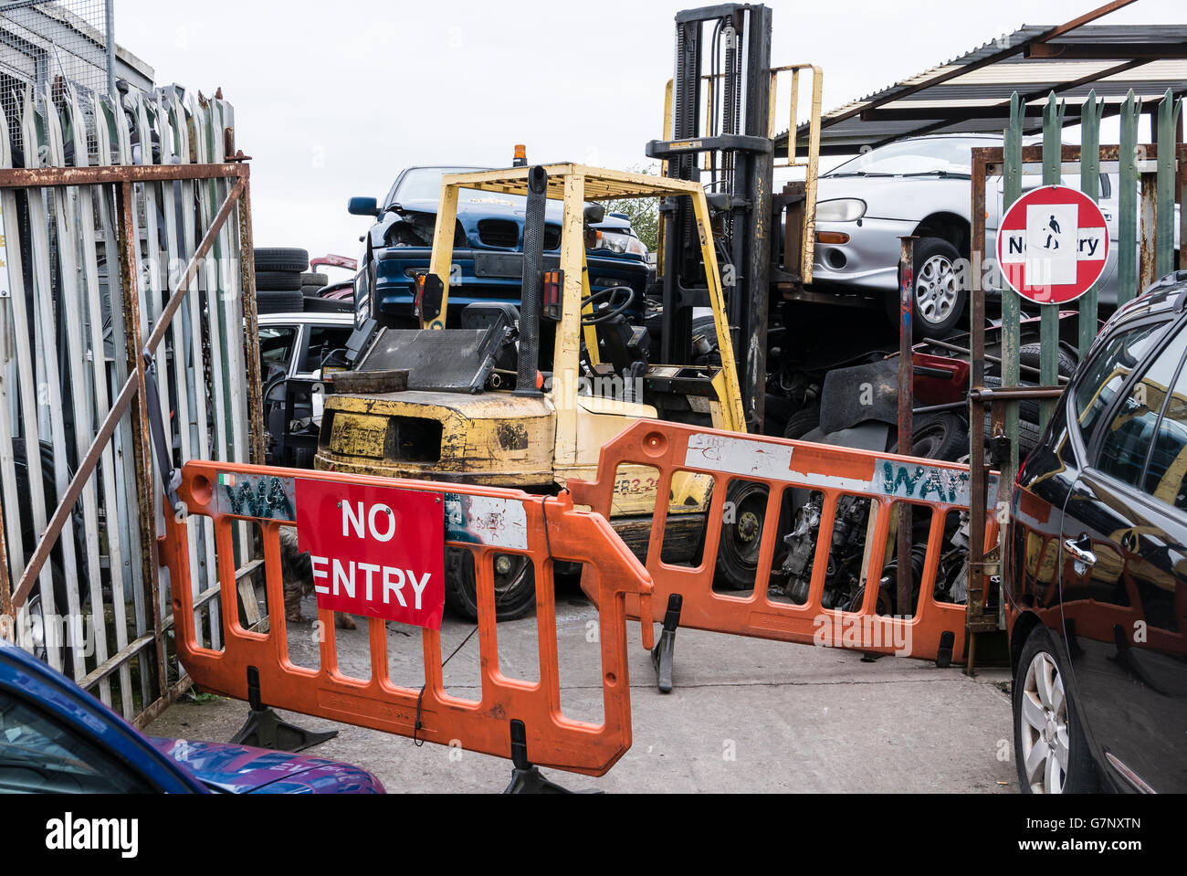 Entrance to a scrap metal yard, with lots of cars for dismantling. Stock Photo