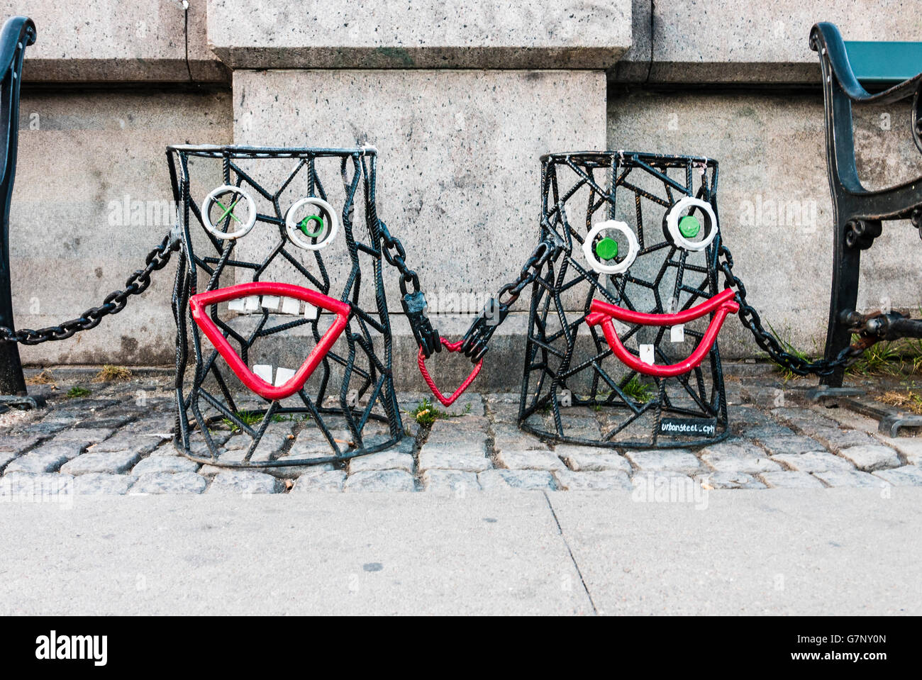 Metal street-art in shape of two bins with faces, holding a heart between them, on the Dronning Louises Bro bridge, Copenhagen Stock Photo