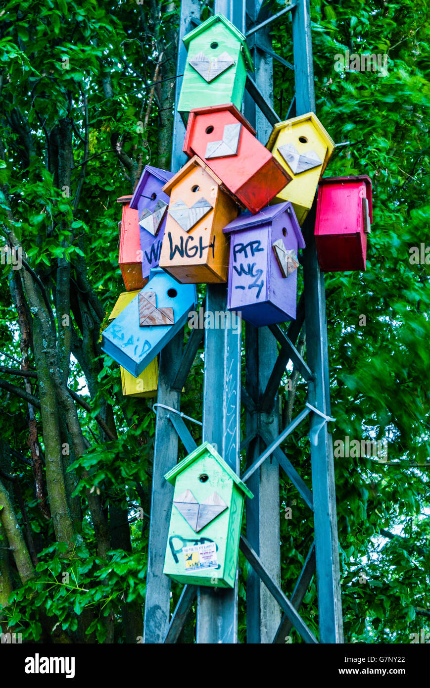 Multicoloured birdboxes on a metal street pole in a park in Copenhagen. Stock Photo