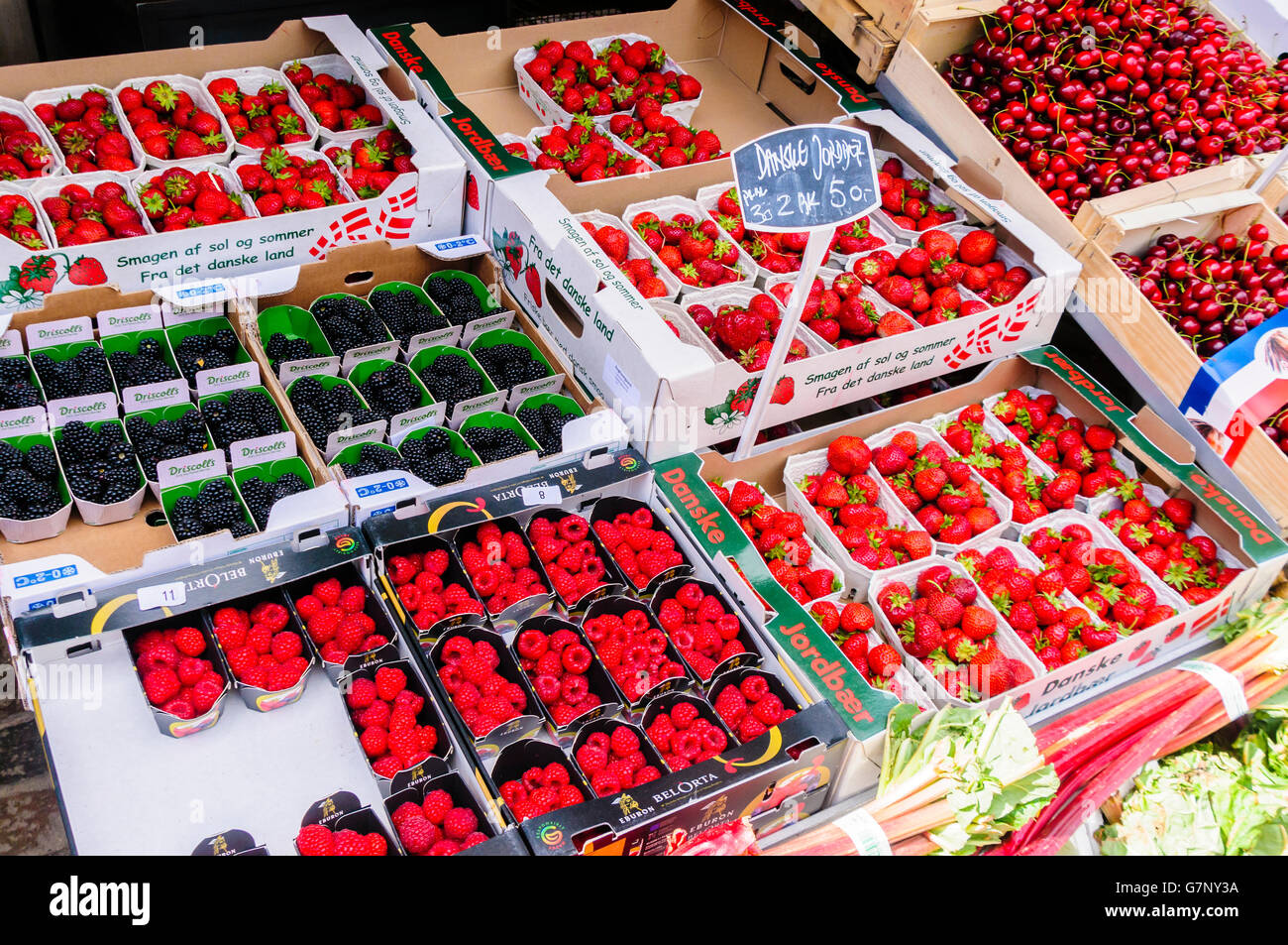 Blackberries, raspberries, strawberries and cherries for sale at a Danish market stall. Stock Photo