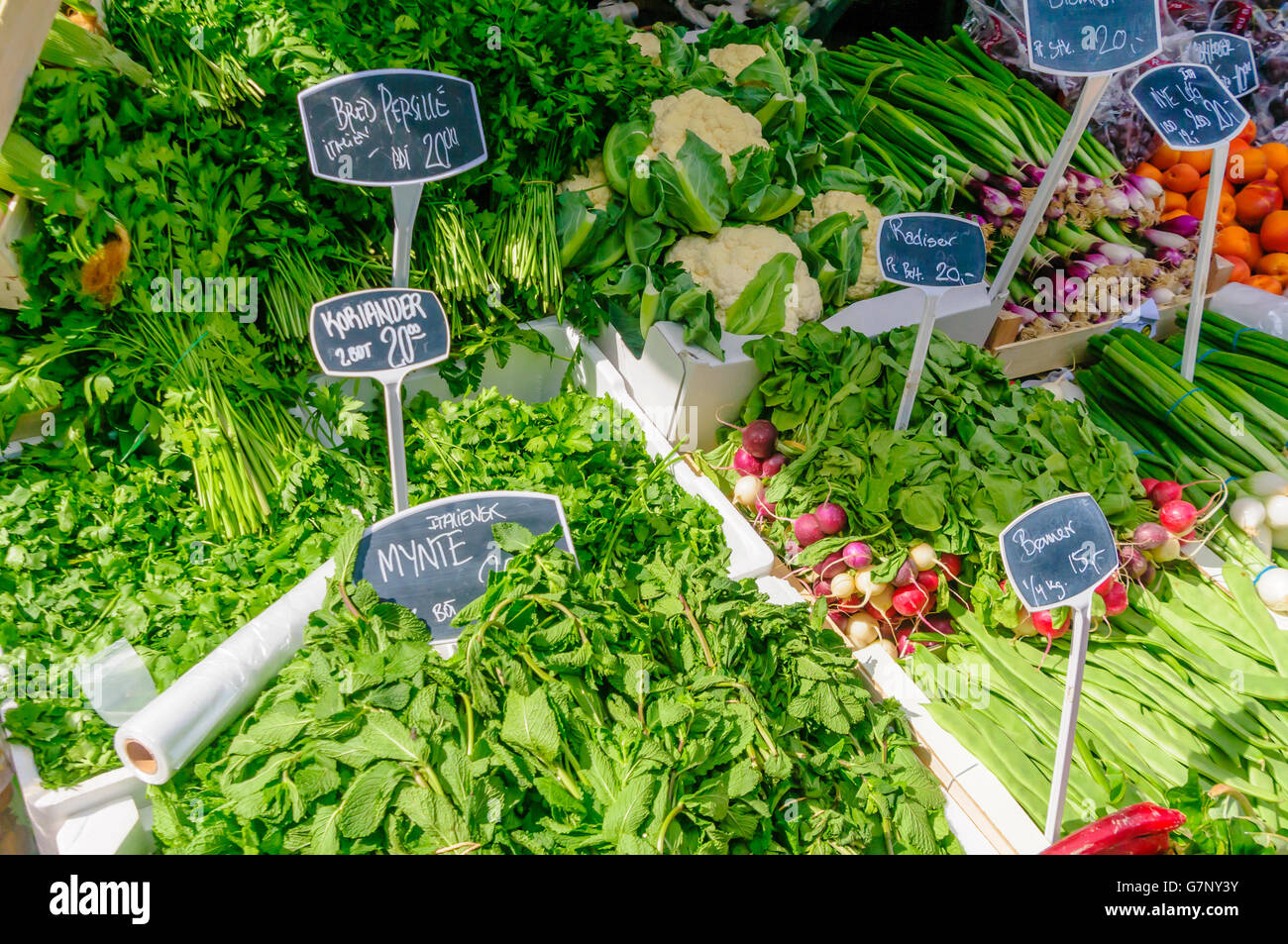 Salad vegetables, cauliflower and herbs for sale at a Danish market stall. Stock Photo