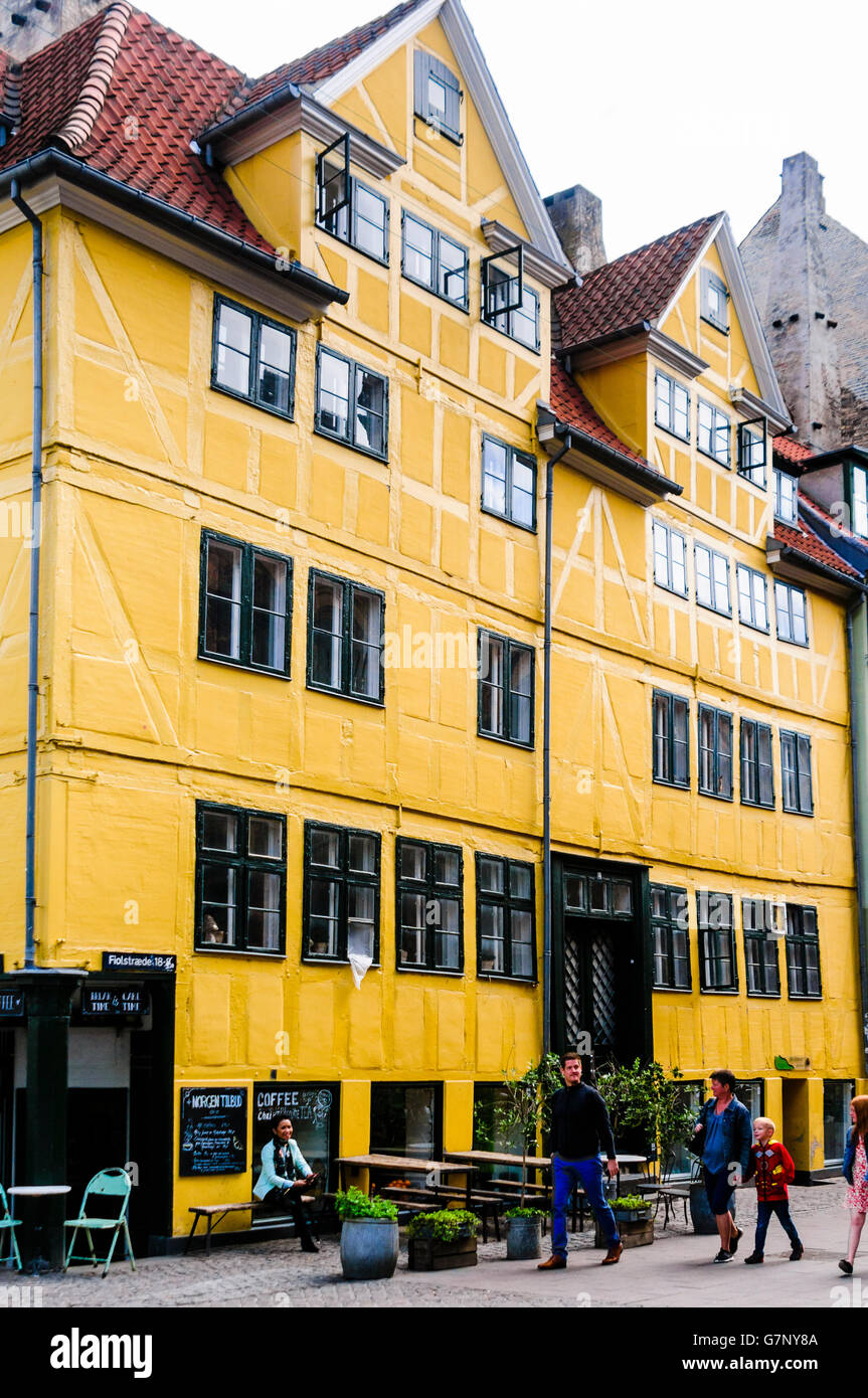 Yellow building with a coffee shop in a street in Copenhagen Stock Photo