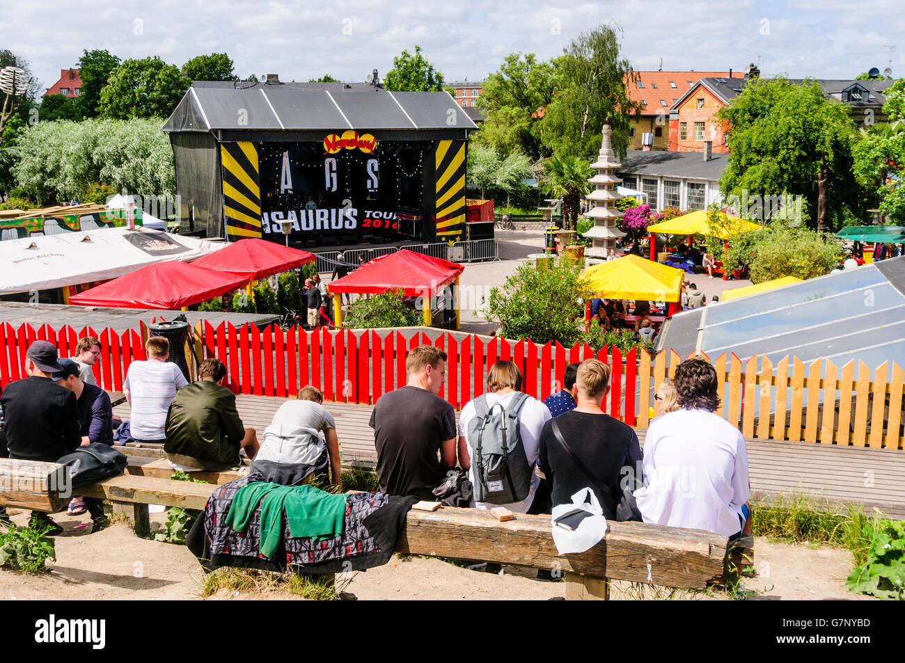 People sitting and relaxing overlooking the main concert stage in Freetown Christiania, Copenhagen. Stock Photo