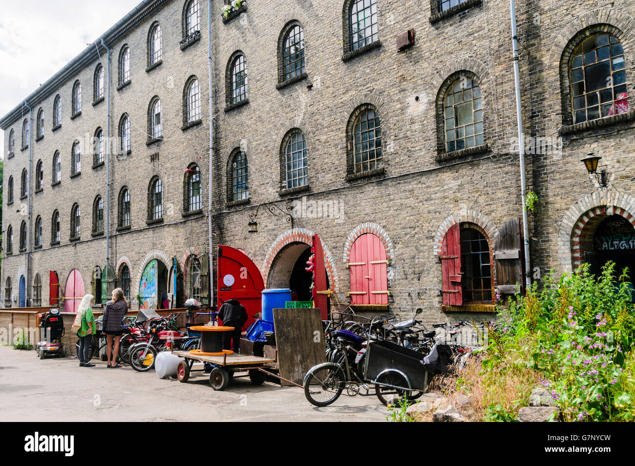 Old mill and former military building, now used as workshops in Freetown Christiania, Copenhagen. Stock Photo
