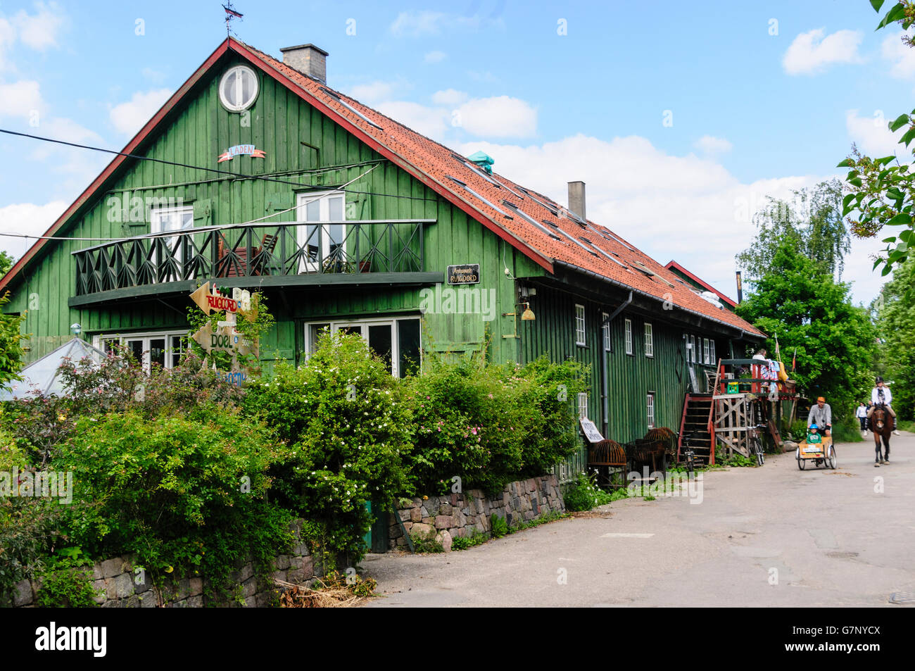 A traditional green wooden house with terracotta tiled roof in Freetown Christiania, Copenhagen Stock Photo