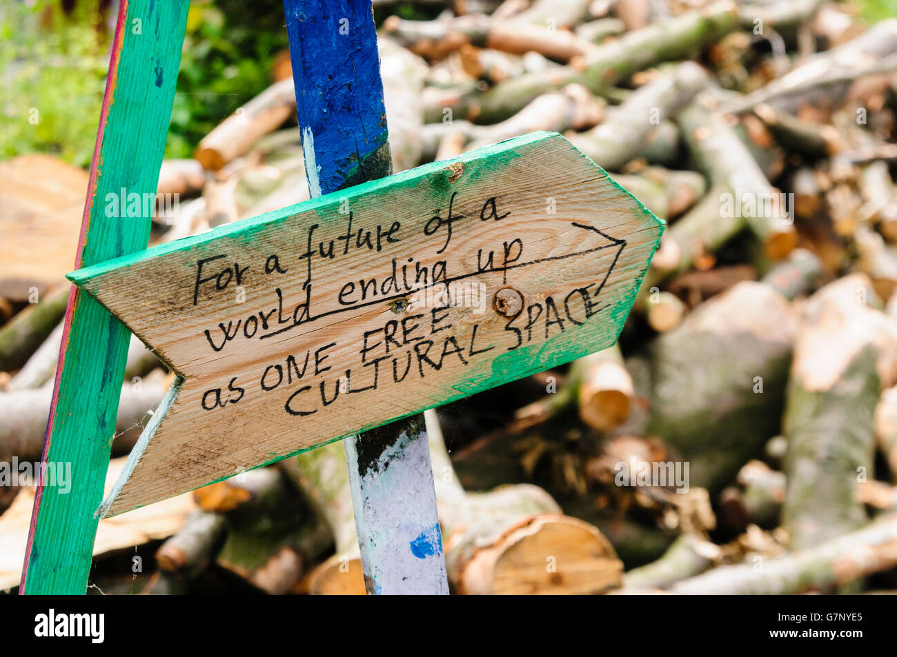 Sign saying 'For a future of a world ending up as one free cultural space' on a pile of wood for a woodburning stove Stock Photo