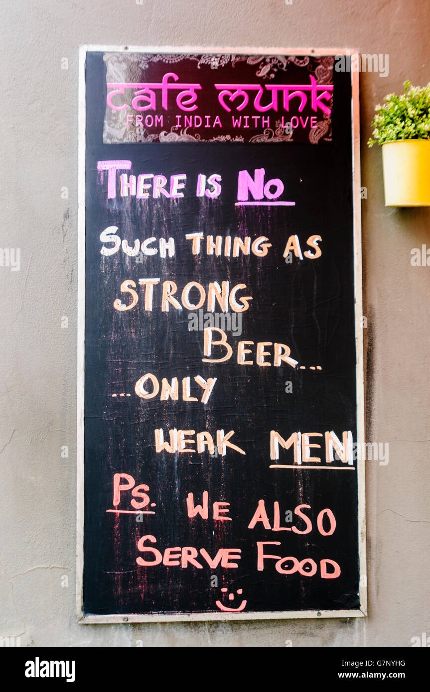 Sign outside Cafe Munk, Copenhagen, saying 'There is no such thing as strong beer, only weak men. PS We also serve food'. Stock Photo