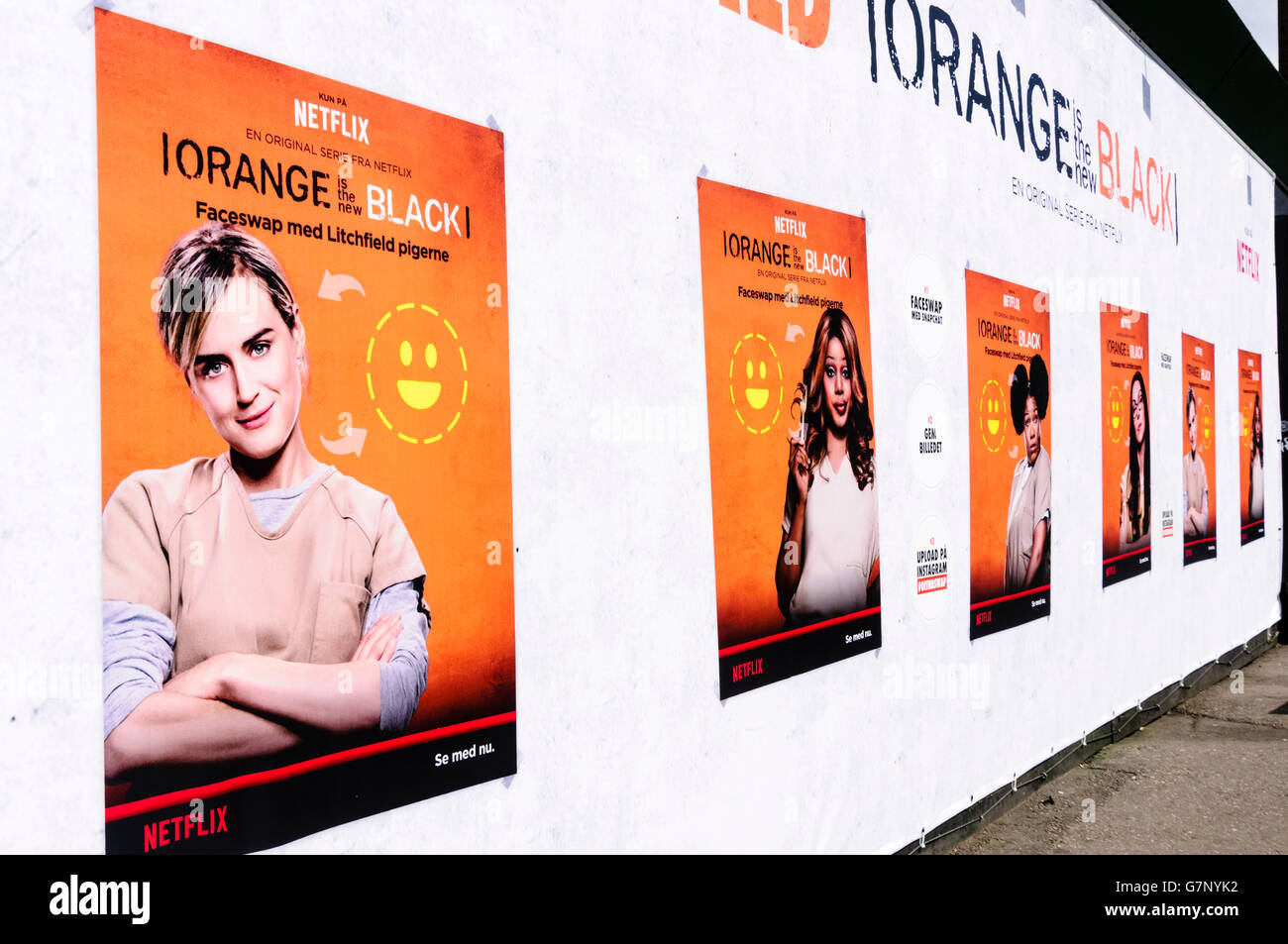 Posters on a hoarding in Copenhagen advertising the new series of the Netflix series 'Orange is the New Black' Stock Photo