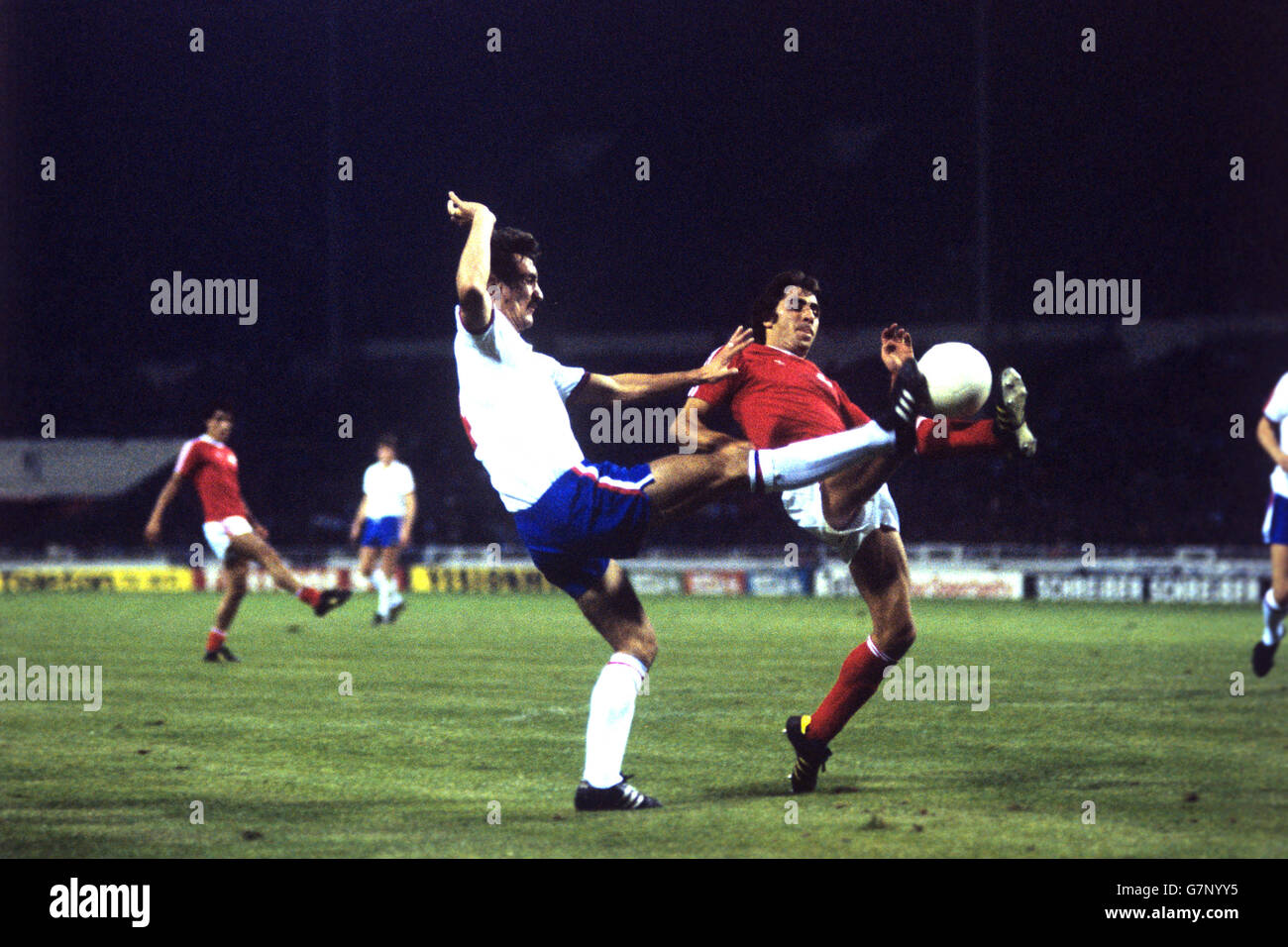 England's Terry McDermott (left) goes up against Switzerland's Otto Demarmels. Stock Photo