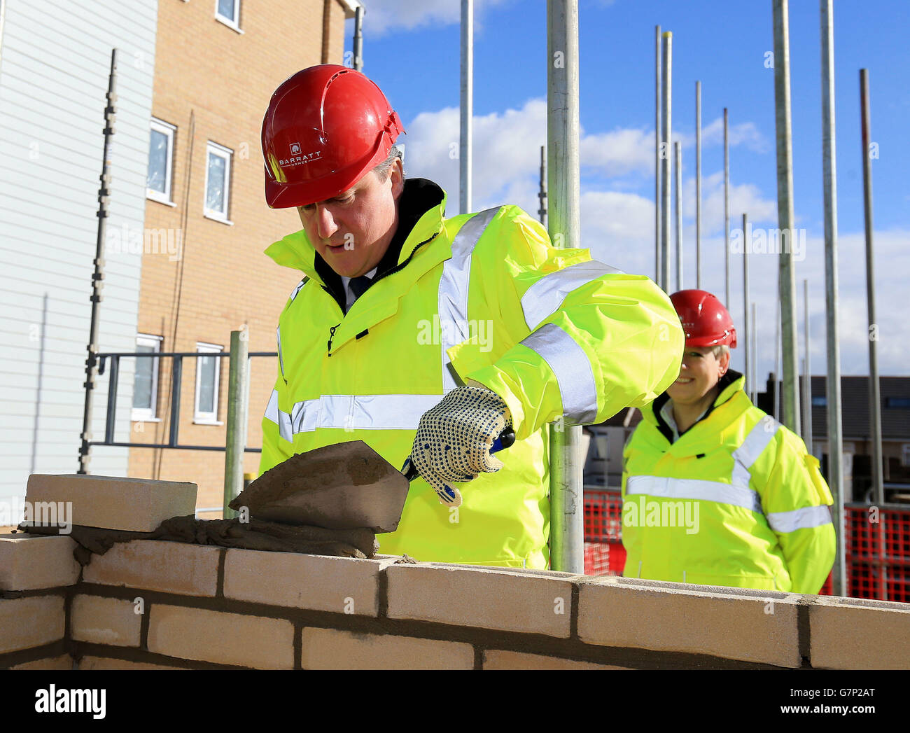 Prime Minister David Cameron tries his hand at brick laying during a ...