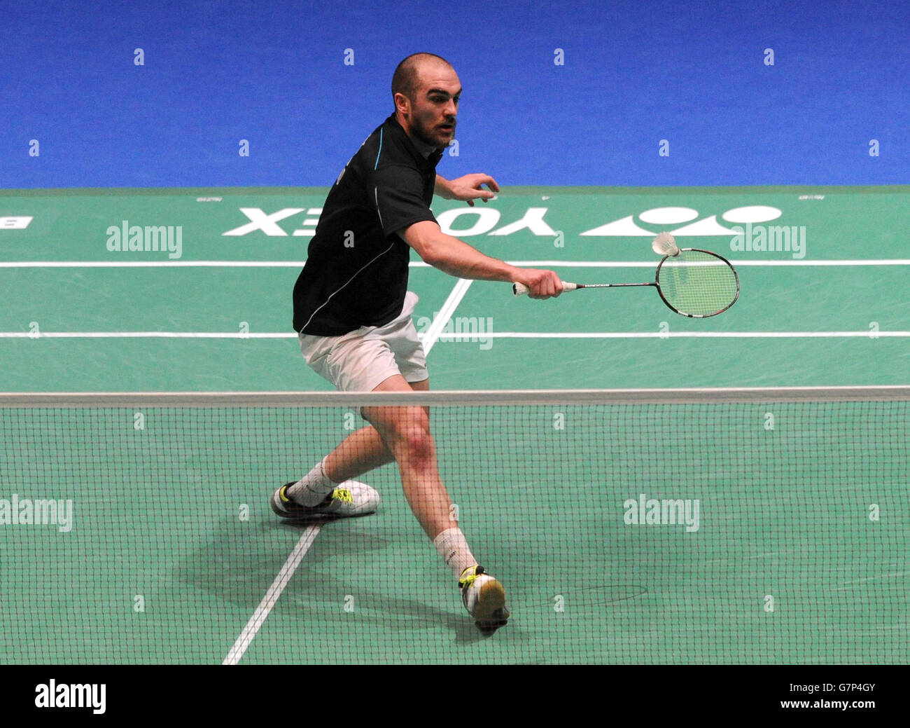 Ireland's Scott Evans plays a shot during day two of the 2015 Yonex All England Badminton Championships at the Barclaycard Arena, Birmingham. Stock Photo
