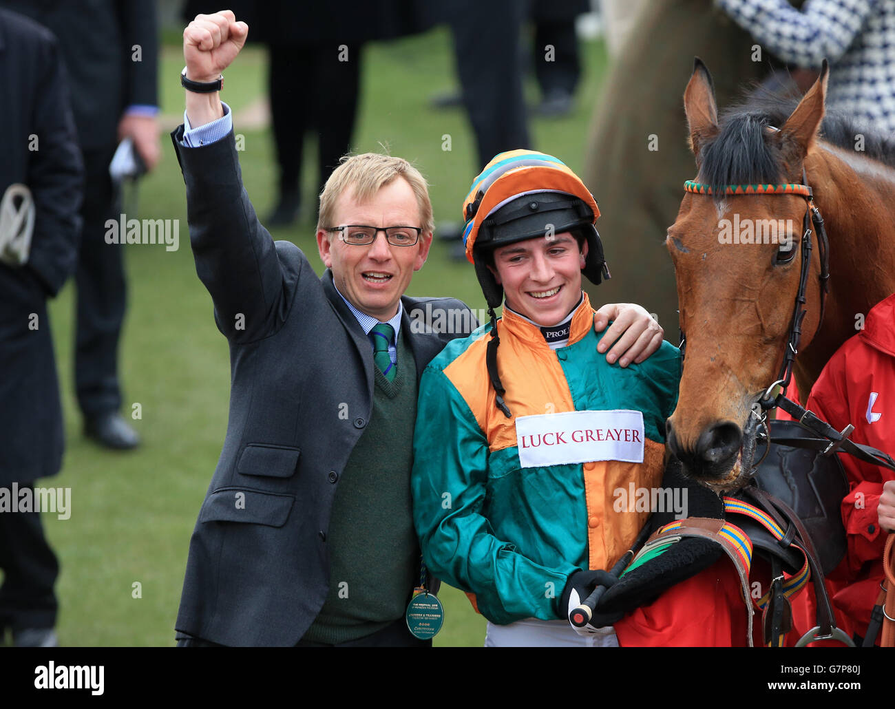Jockey Gavin Sheehan (right) celebrates winning the Ladbrokes World Hurdle with Cole Harden alongside trainer Warren Greatrex (left), on St Patrick's Day during the Cheltenham Festival at Cheltenham Racecourse. PRESS ASSOCIATION Photo. Picture date: Thursday March 12, 2015. See PA story RACING Cheltenham. Picture credit should read: Nick Potts/PA Wire. Stock Photo