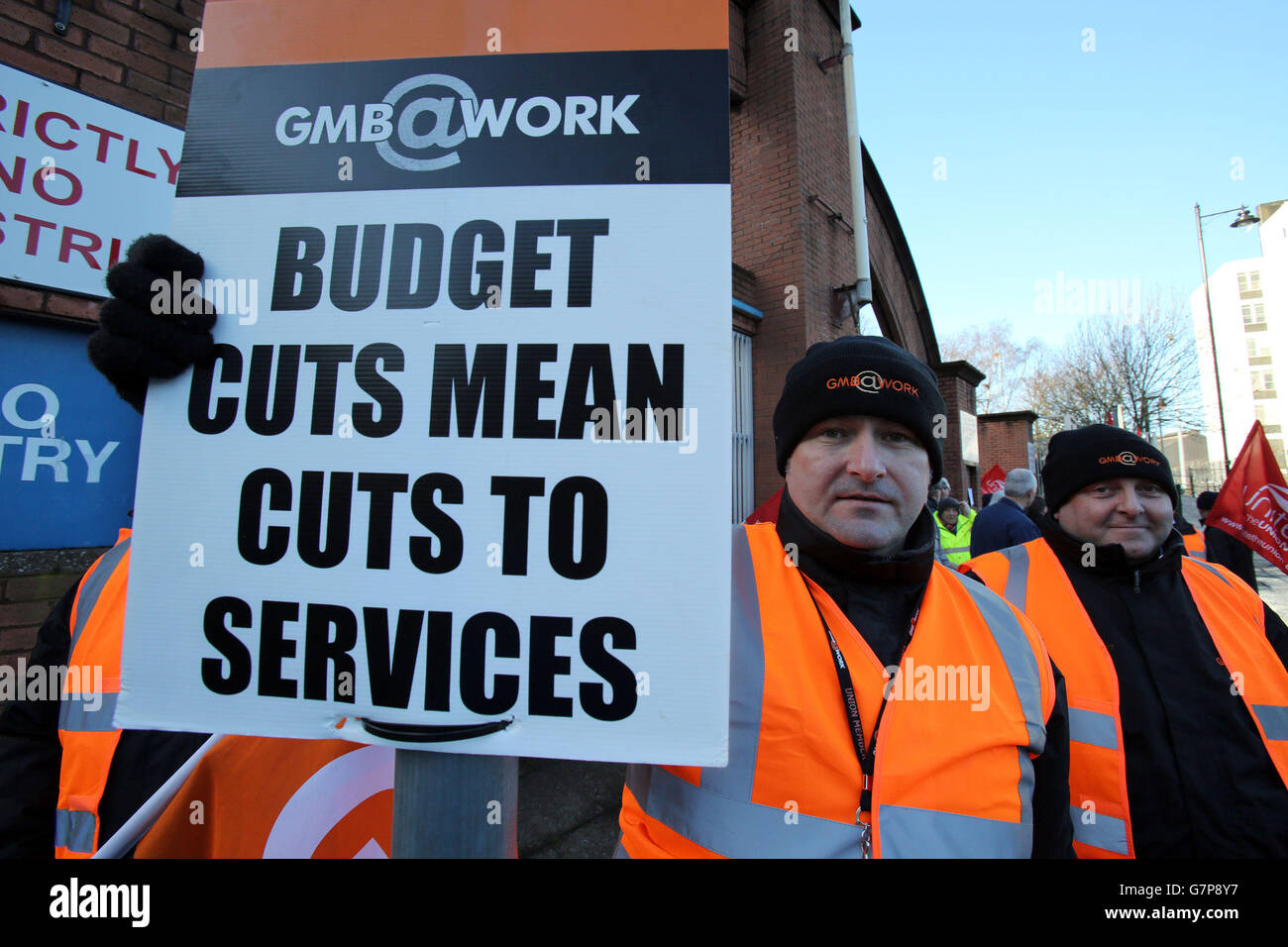 Workers protest outside the Great Victoria street Rail and Bus depot in Belfast, as tens of thousands of public service workers were taking part in the 24 action over Stormont spending cuts. Stock Photo