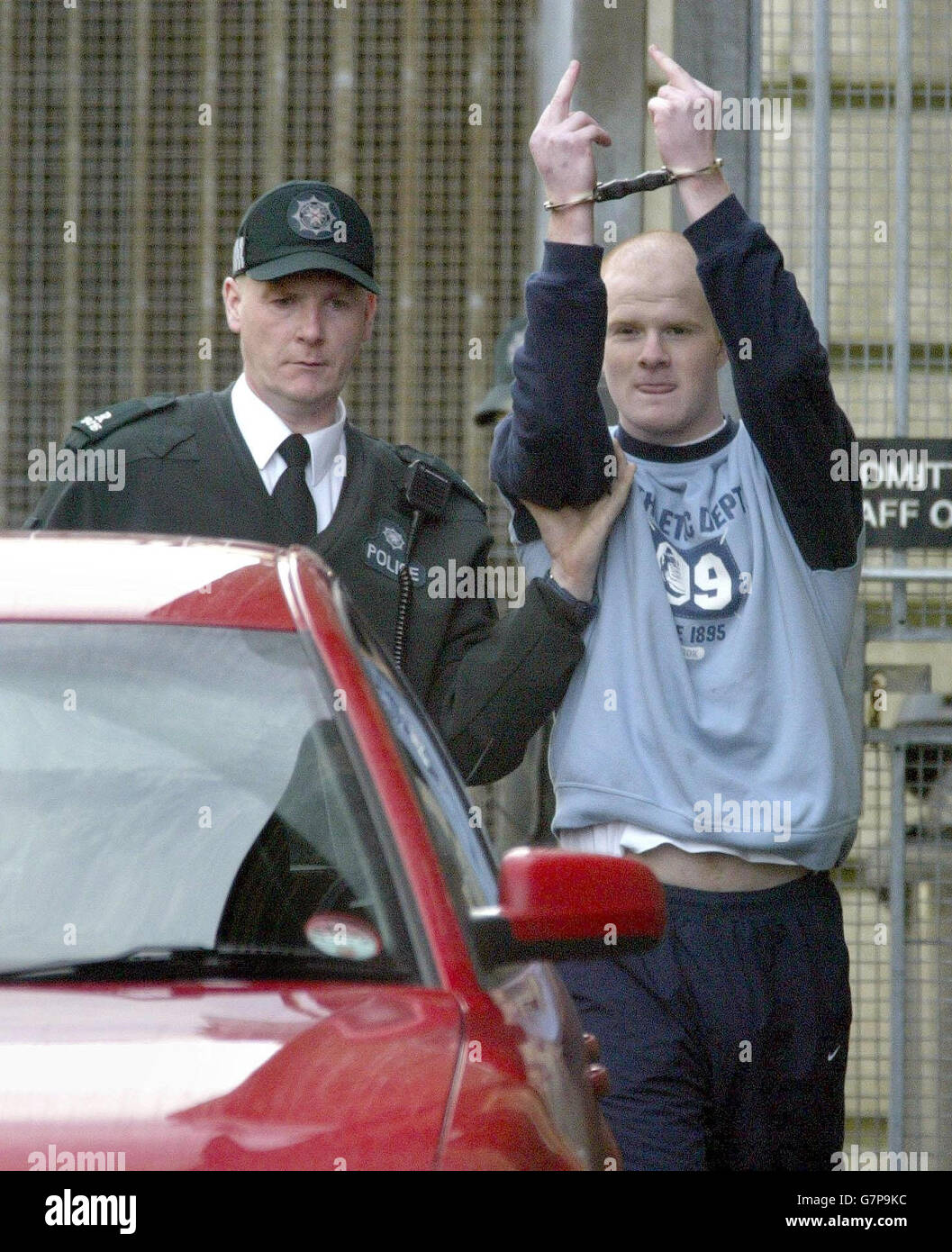 Christopher Smily, 20, from Ballymena Co Antrim,is led away. He is one of five people charged with possession of incendiary devices and Real IRA membership. The four men and one woman were arrested after police found three firebombs in a house in Fisherwick Gardens in Ballymena on Saturday. Ballymena Magistrates Court was told on Tuesday that when charged the accused had either made no reply or denied the allegations. The five, all from Ballymena in County Antrim, were remanded in custody. Stock Photo