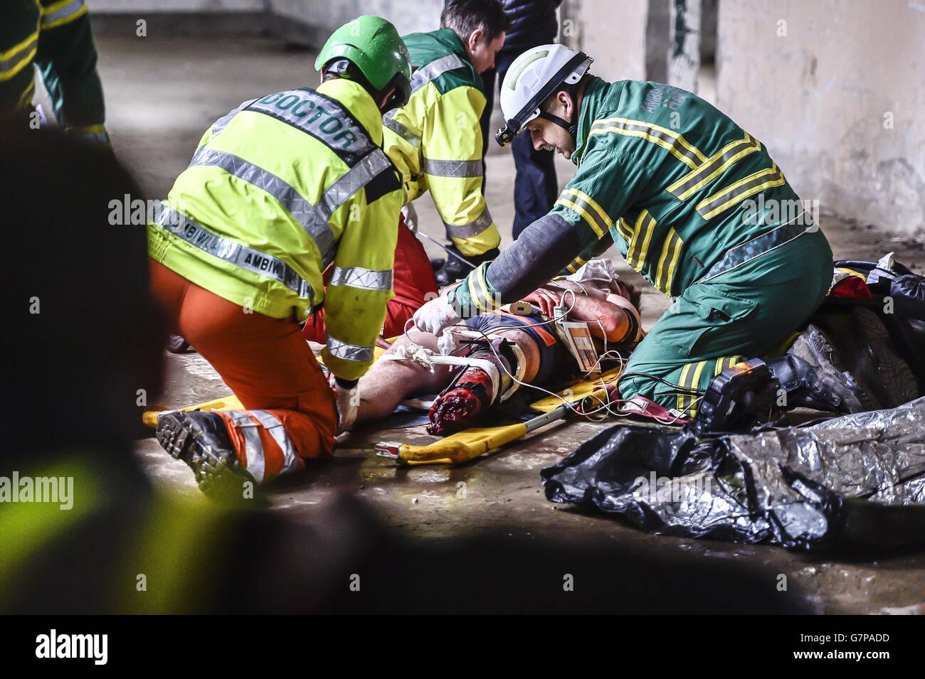 A medical Critical Care Team work on a casualty, posed by an actor, during a live multi-agency training exercise near Newport in Wales. Stock Photo