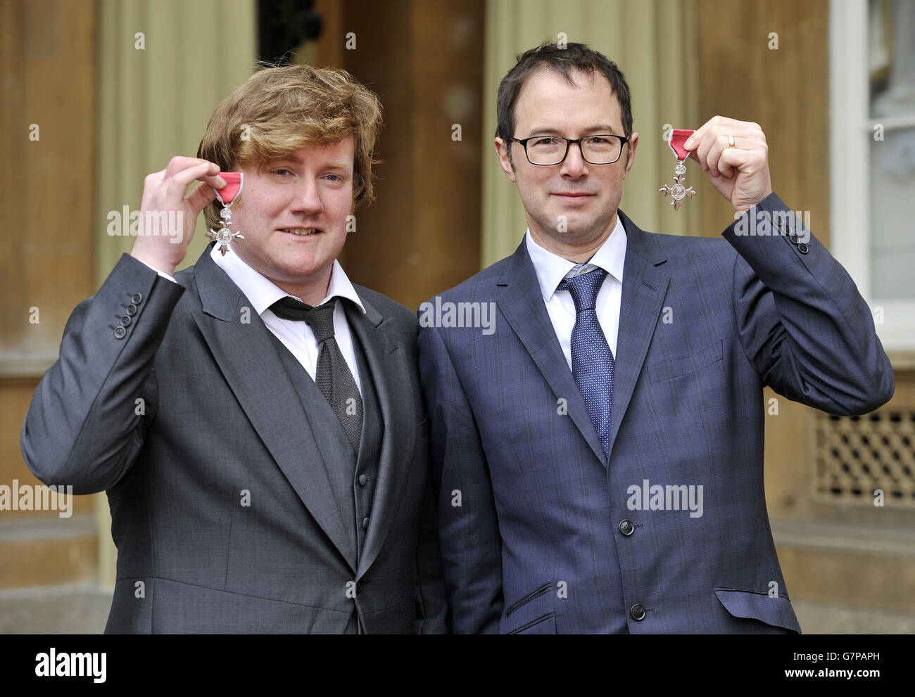 Ceramic artist Paul Cummins (left) and theatre designer Thomas Piper, hold their Member of the Order of the British Empire (MBE) medals presented to them by the Duke of Cambridge, for services to, Art and First World War Commemorations and Theatre and First World War Commemorations, respectively, at an Investiture ceremony at Buckingham Palace in central London. Stock Photo