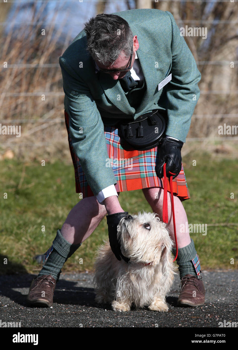 Kenny Allan, from Eyemouth, with Buzet the Dandie Dinmont Terrier, as they visit Sir Walter Scott's home at Abbotsford, Melrose, in the Scottish Borders, on the 200th anniversary of the publication of the book Guy Mannering which gave the breed its distinctive name. Stock Photo