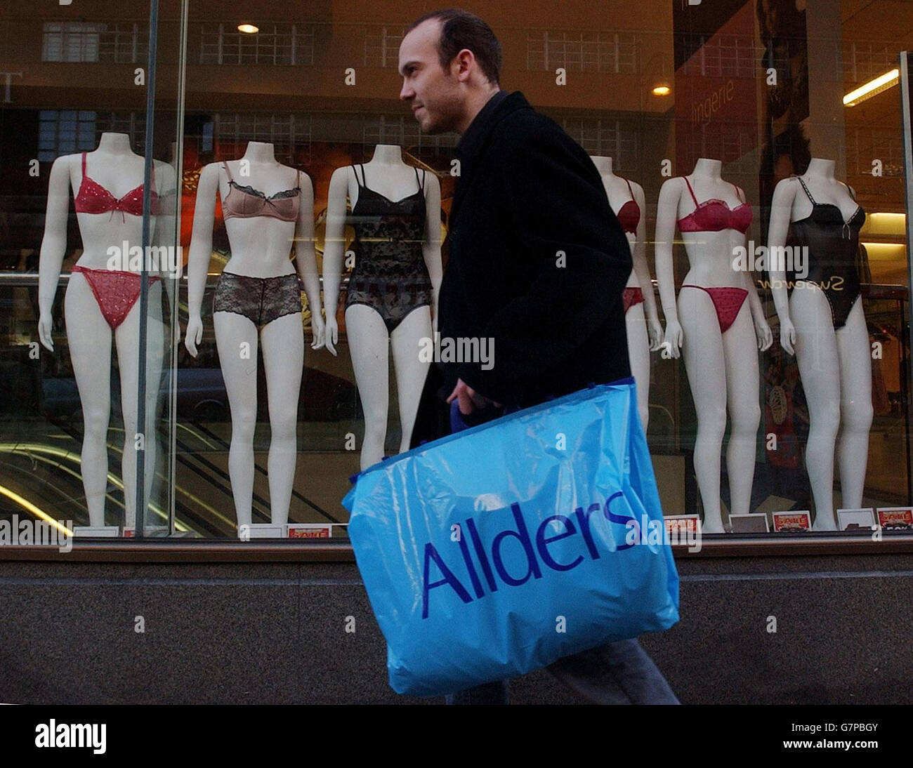 An Allders customer walks past the department store's Oxford Street branch, amid speculation that bankers for department stores group Allders are poised to appoint administrators for the loss-making chain. Stock Photo