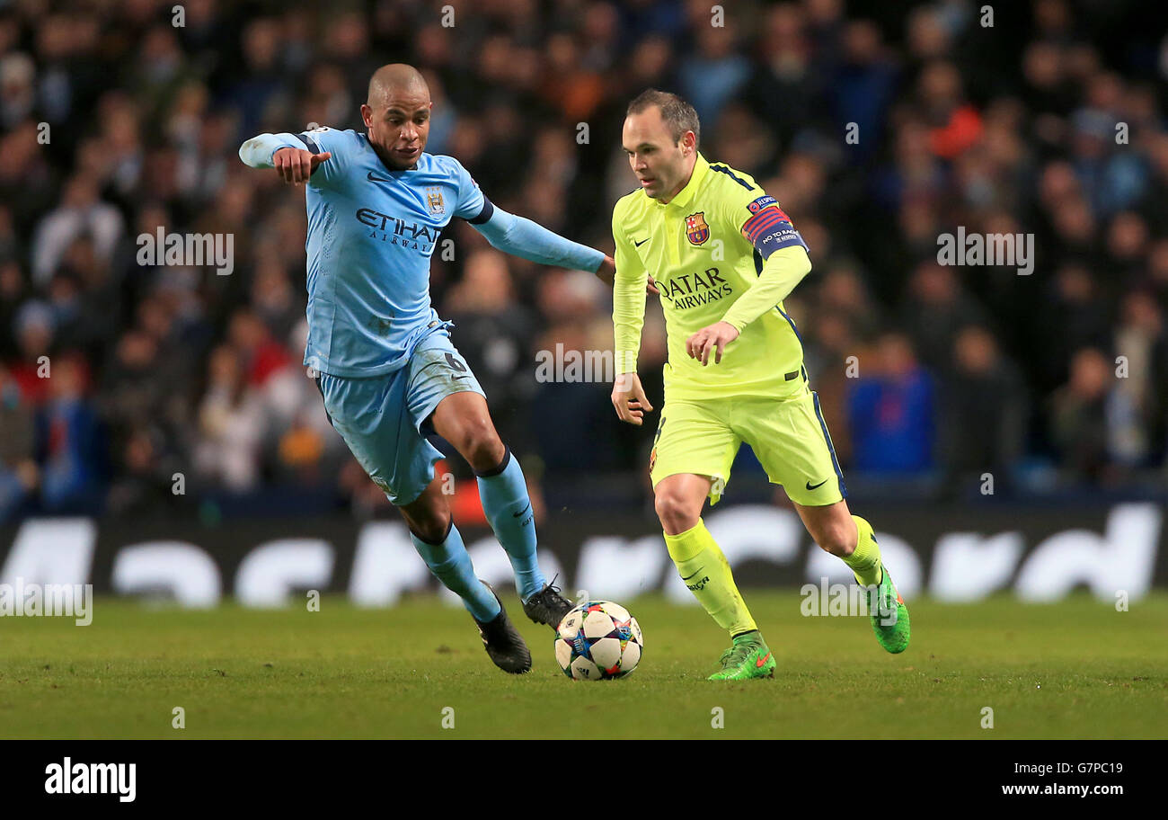Soccer - UEFA Champions League - Round of 16 - First Leg - Manchester City v Barcelona - Etihad Stadium. Manchester City's Francisco Fernando and Barcelona's Andres Iniesta battle for the ball Stock Photo