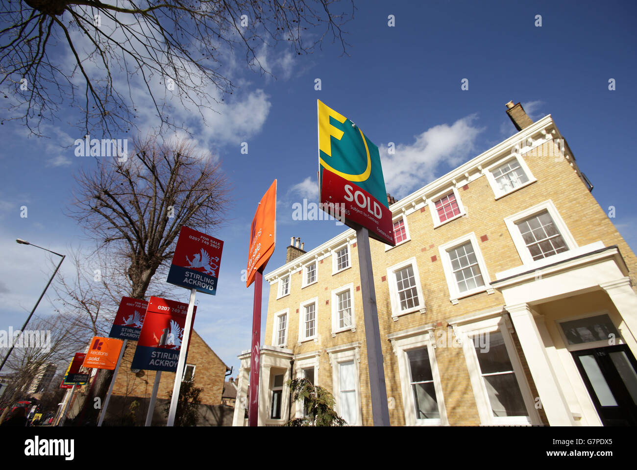 A row of Sold, For Sale and Let By signs displayed outside houses in Clapton, east London Stock