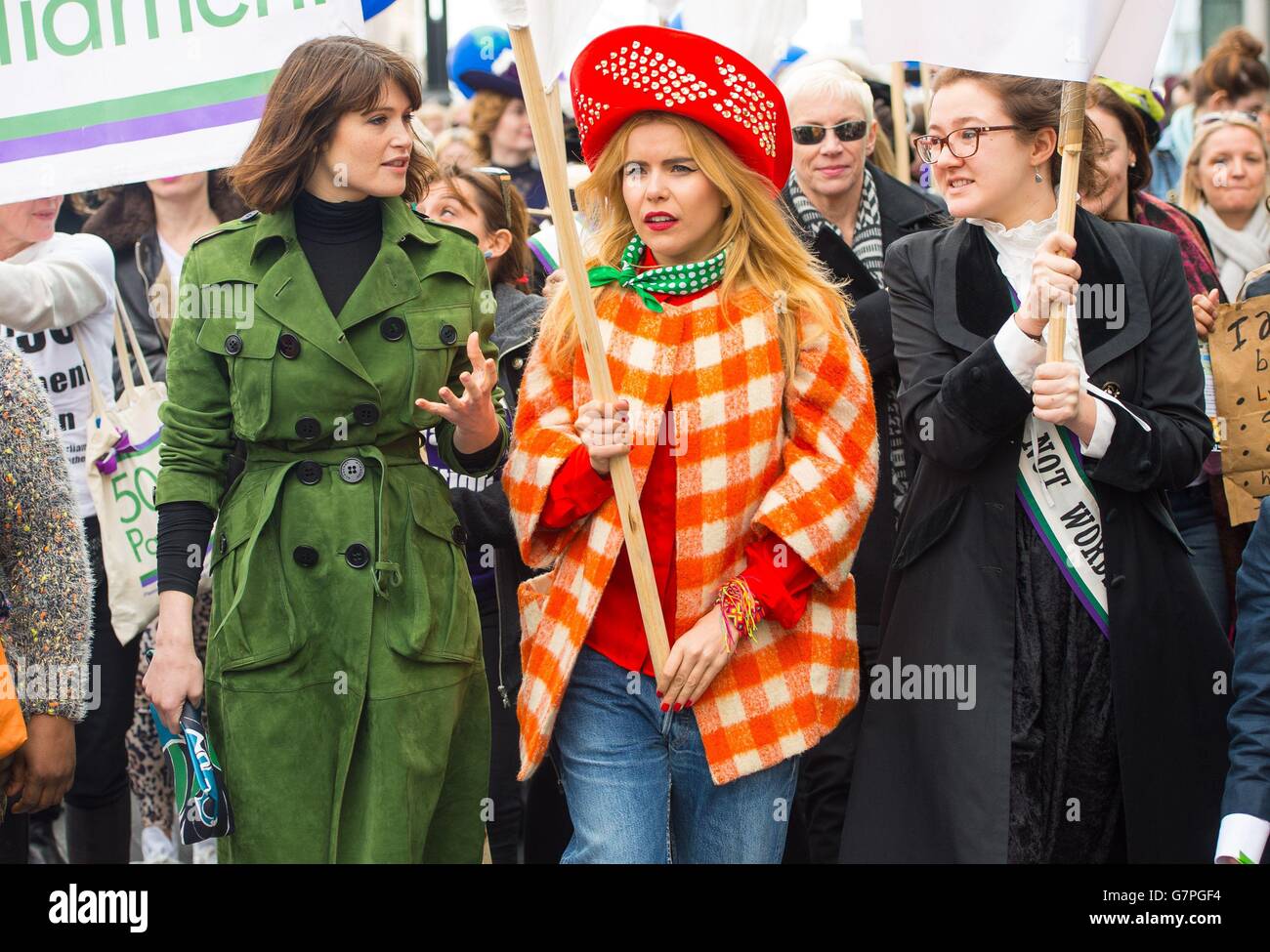 (left to right) Gemma Arterton, Paloma Faith and the great-great-granddaughter of Emmeline Pankhurst, Laura Pankhurst take part in CARE International's Walk in Her Shoes march in central London, to mark International Women's Day. Stock Photo